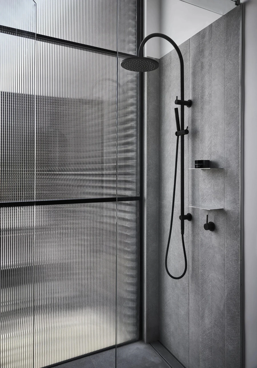 Grey tiled shower and fluted glass screen