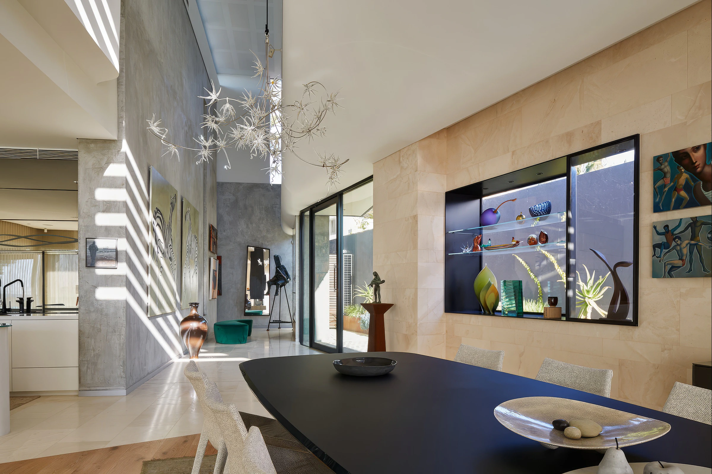 Dining area beside stone feature wall and illuminated display shelf