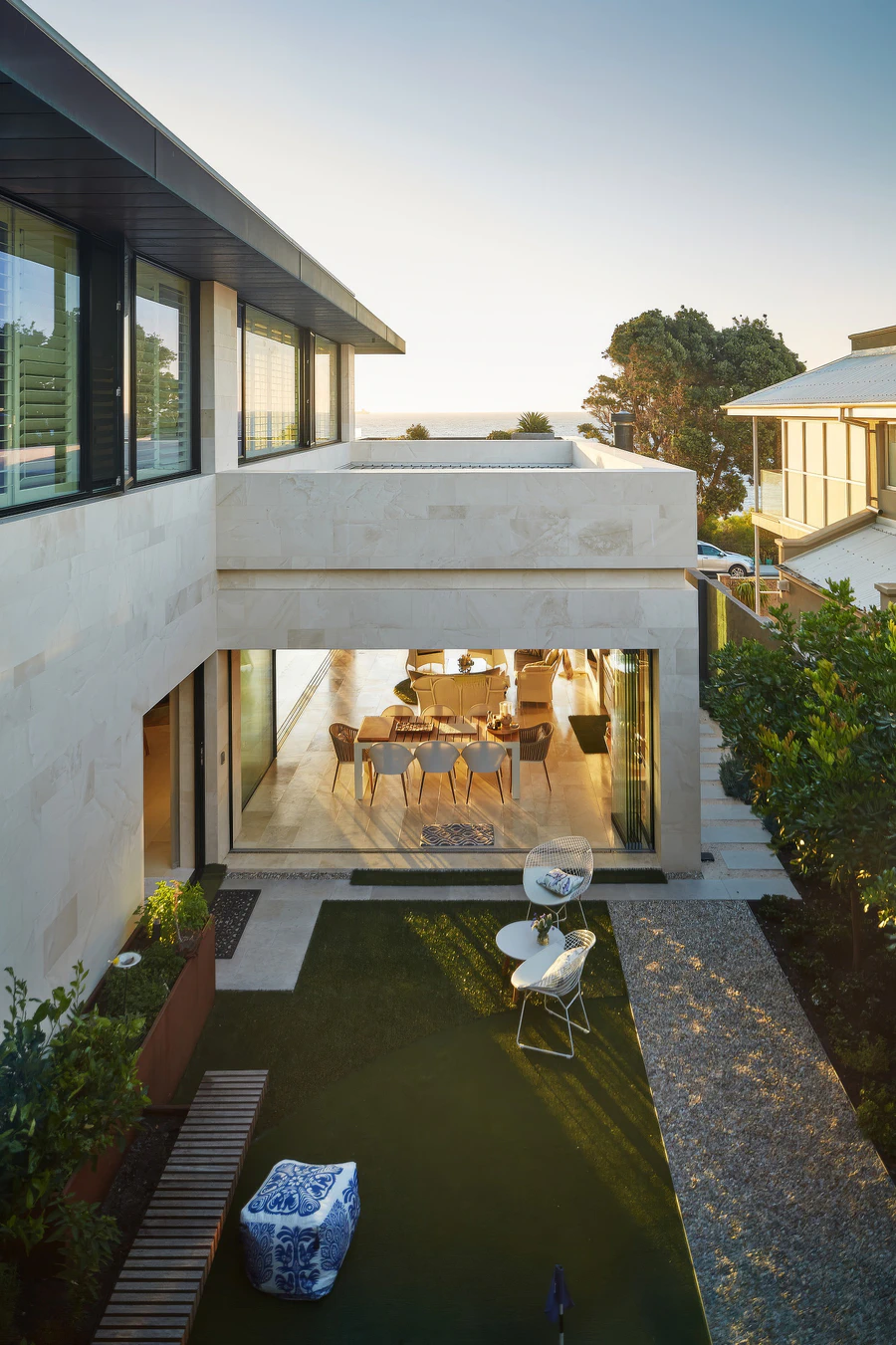 Two-storey house courtyard and open-plan living area overlooking the ocean