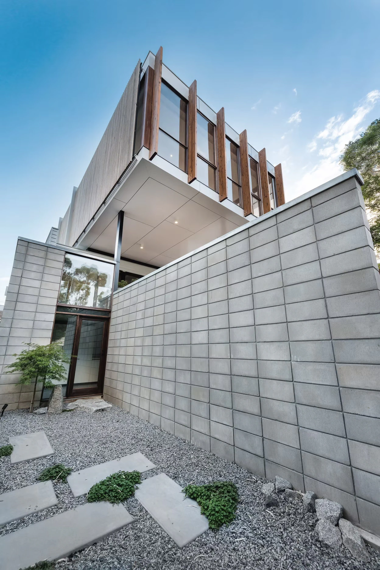 The garden is structured with stone paths, gravel, and carefully pruned plantings