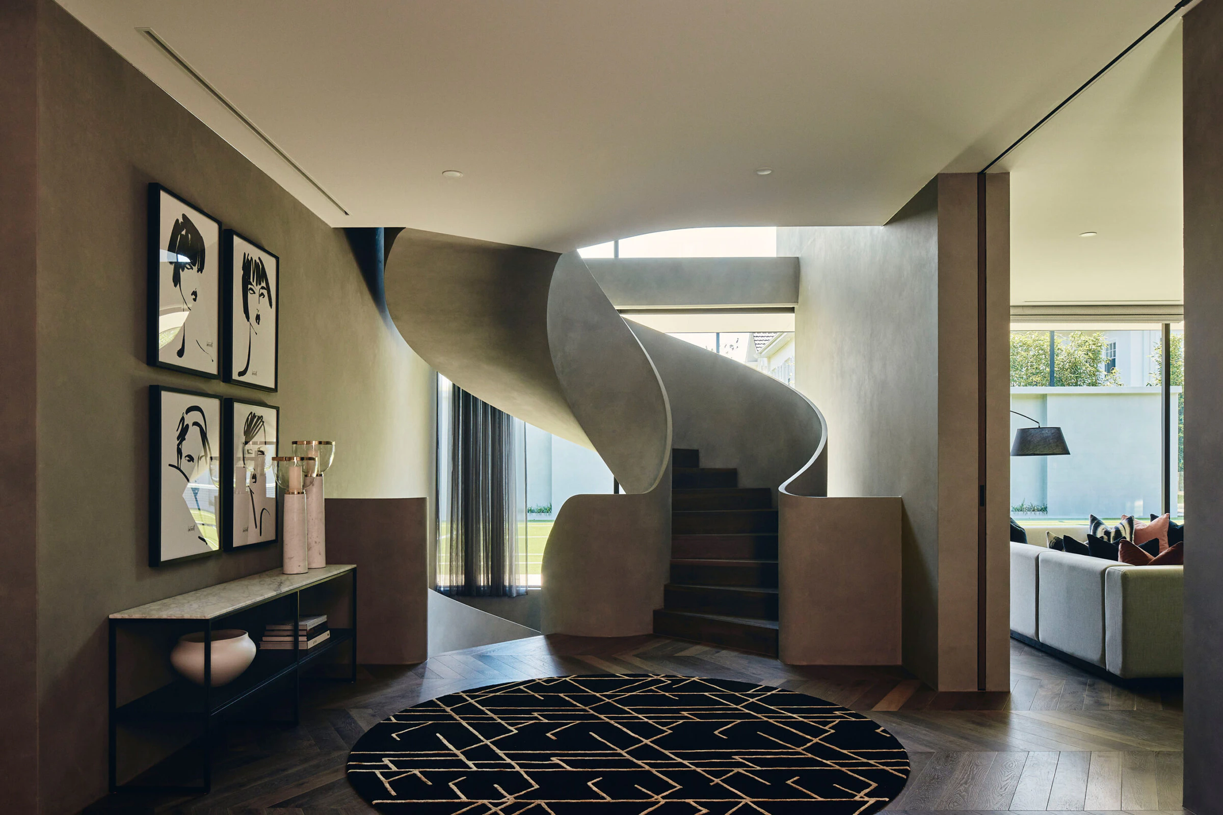 Concrete ribbon staircase and chevron timber entry flooring