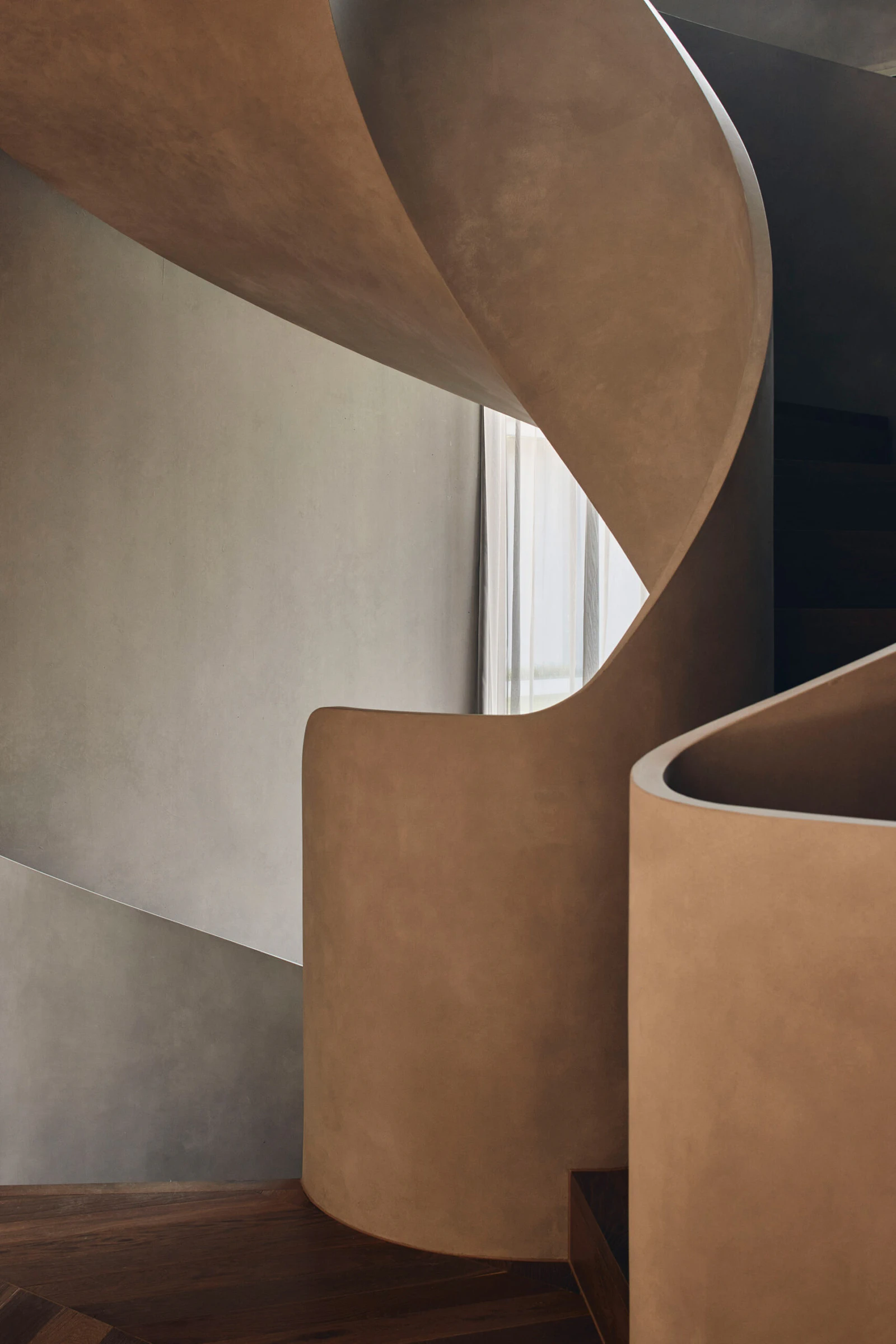 Sculptural concrete staircase and timber flooring in Toorak home