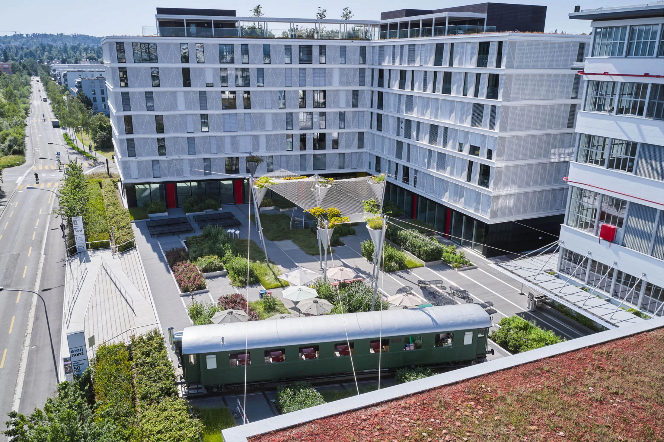 Emil North apartment complex plaza and railway carriage restaurant