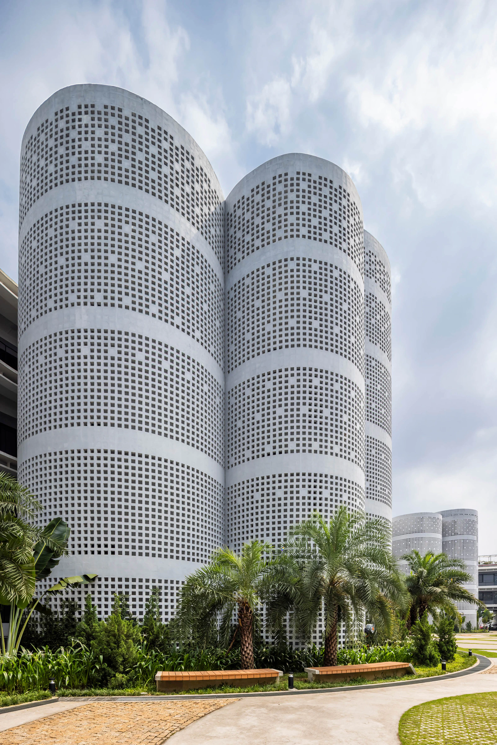 Perforated cylindrical service cores in Infinity Village campus