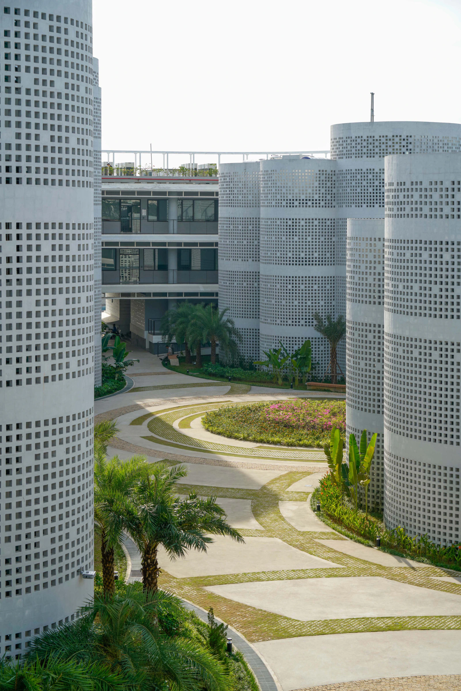 Infinity Village courtyard and perforated cylindrical office cores