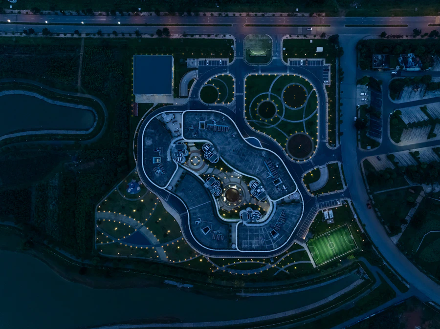 Infinity Village double-loop campus and landscaped courtyards at dusk
