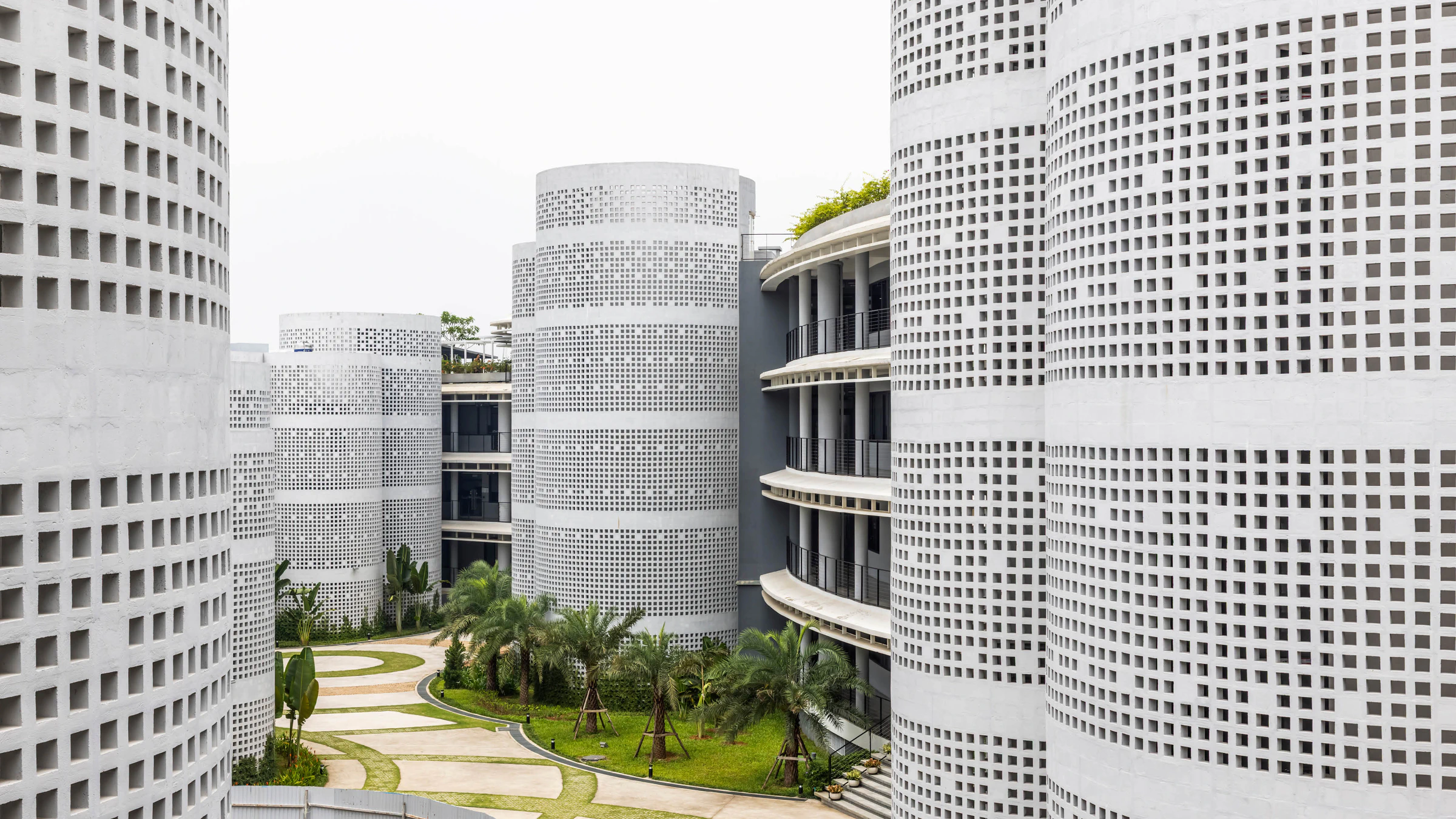 Infinity Village perforated cylindrical cores and landscaped courtyard