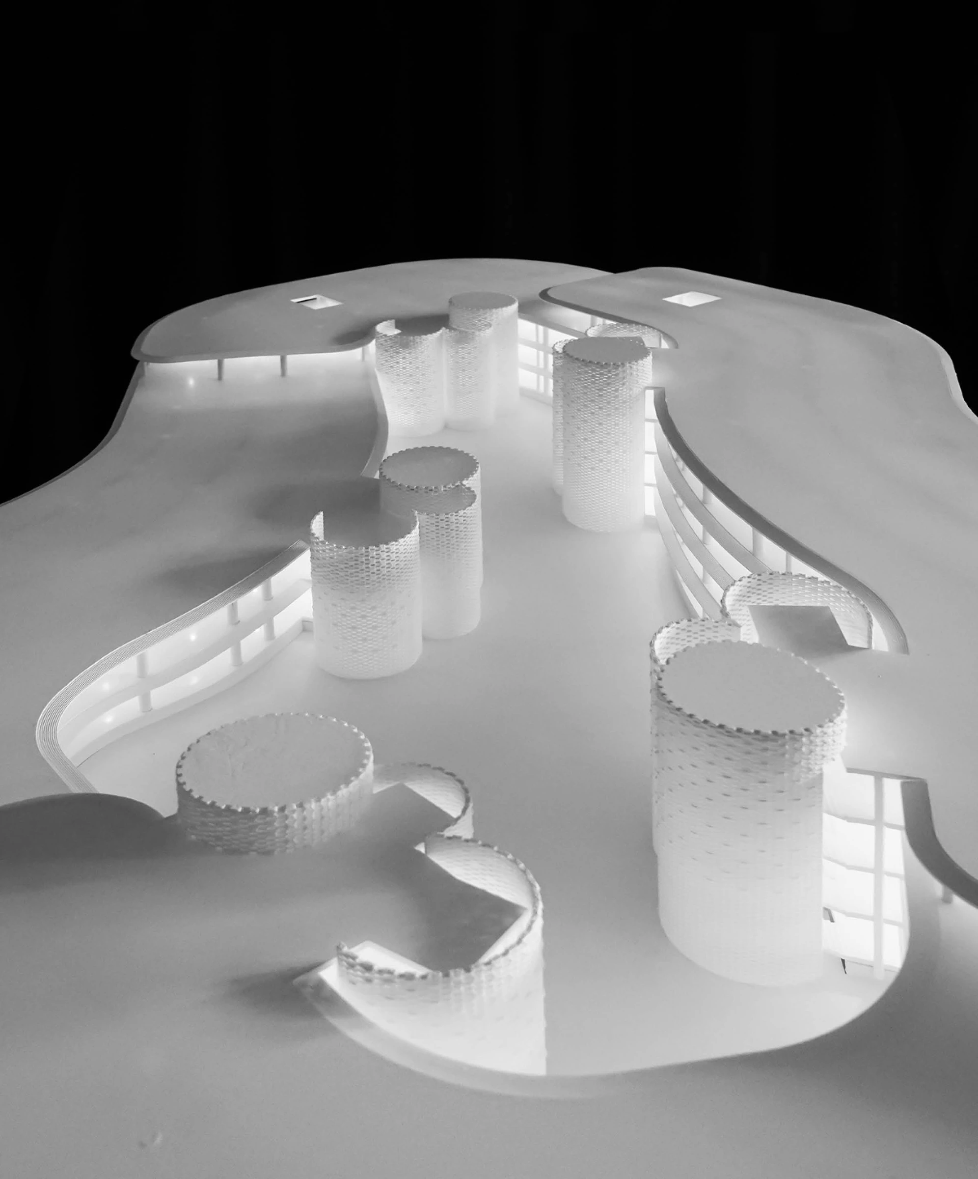 Infinity Village architectural model showing looped campus and cylindrical cores
