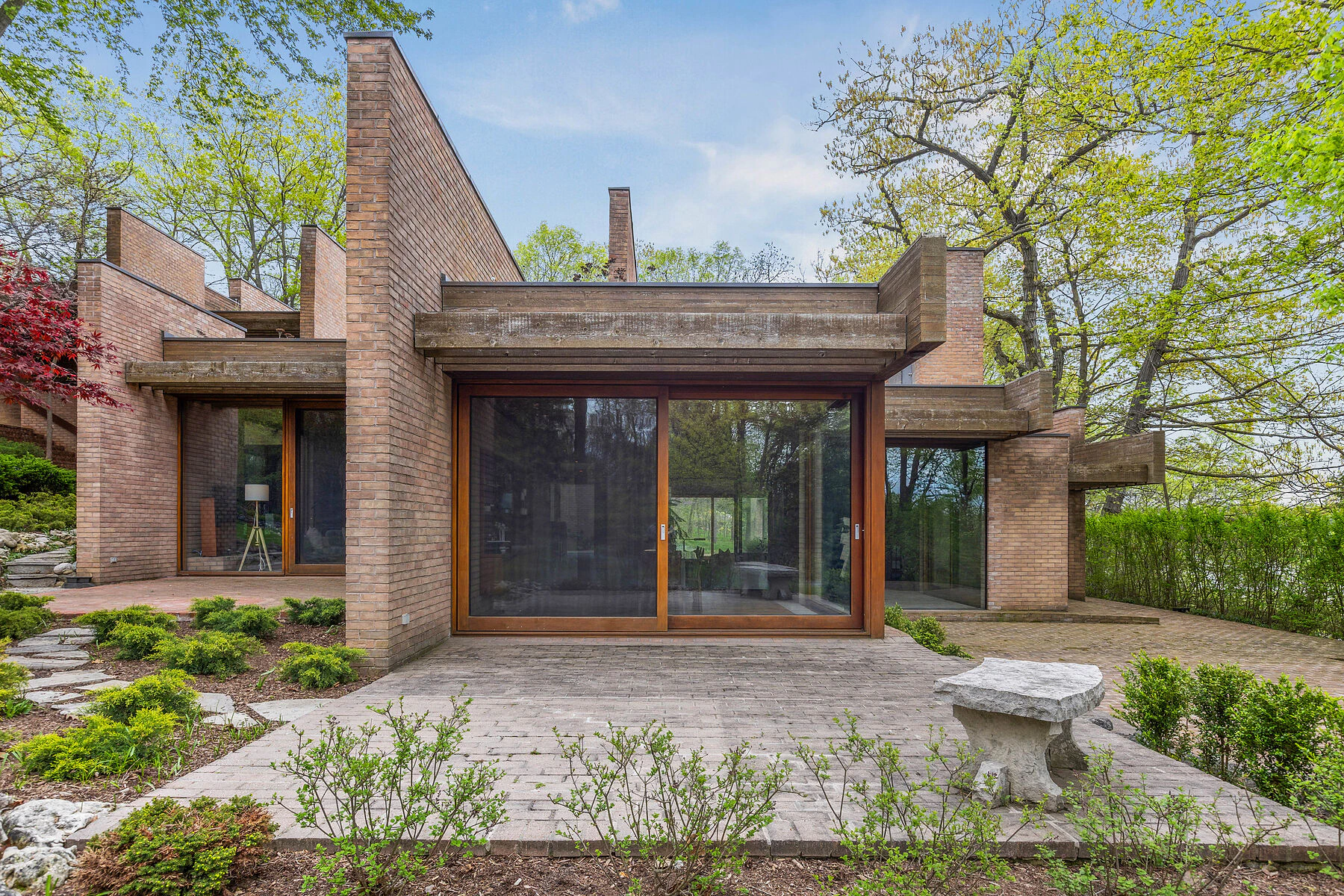 Brick house with large glass doors and garden patio
