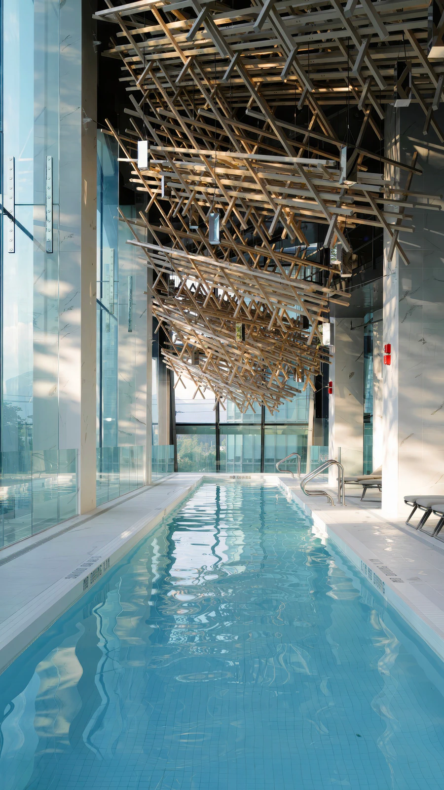 Indoor swimming pool with a suspended cloud of interlocking members, an interpretation of the principles of kigumi joinery