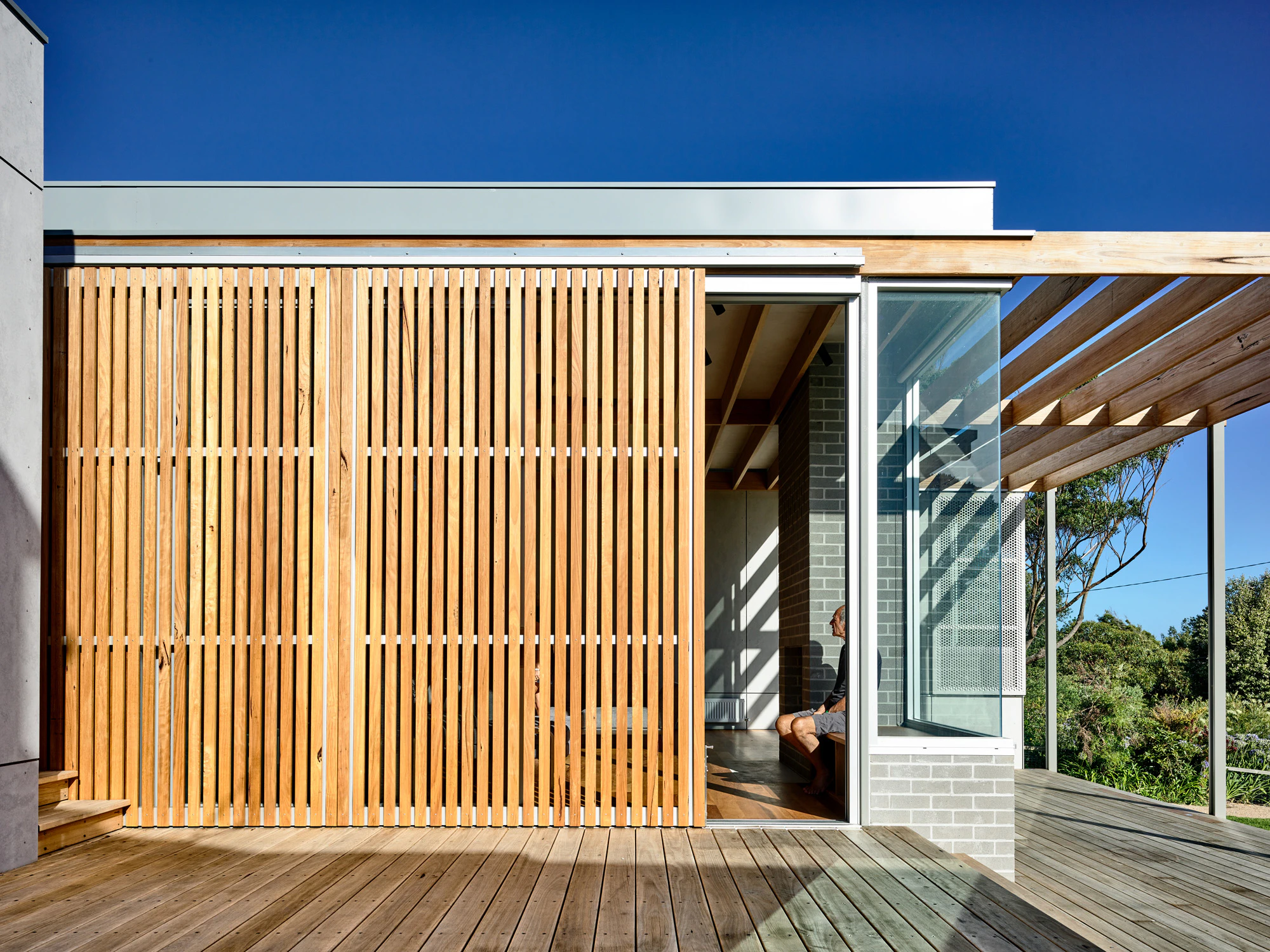 Seaberg timber slatted screens and decked coastal house facade