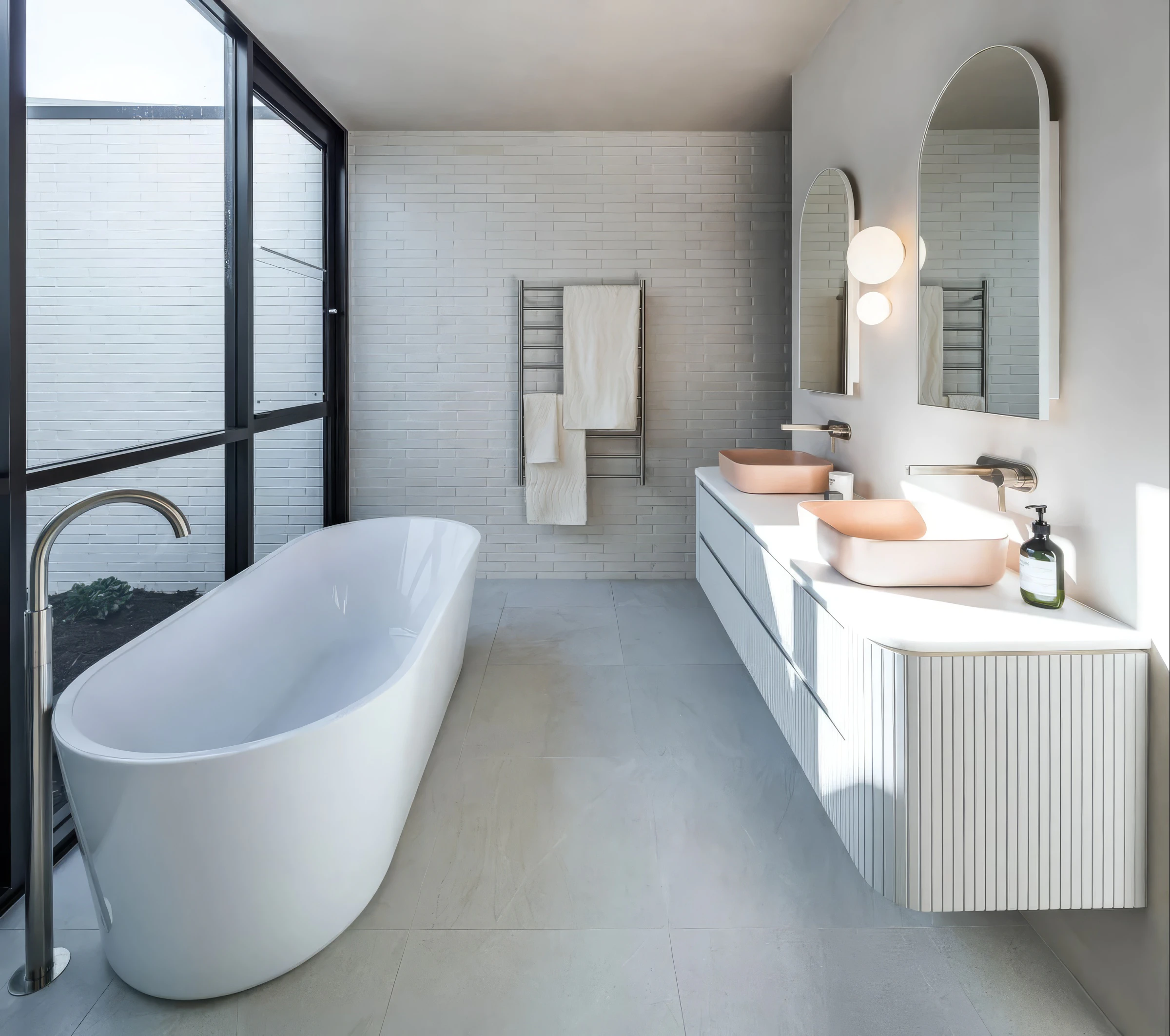 Freestanding bath, peach basins and arched bathroom mirrors