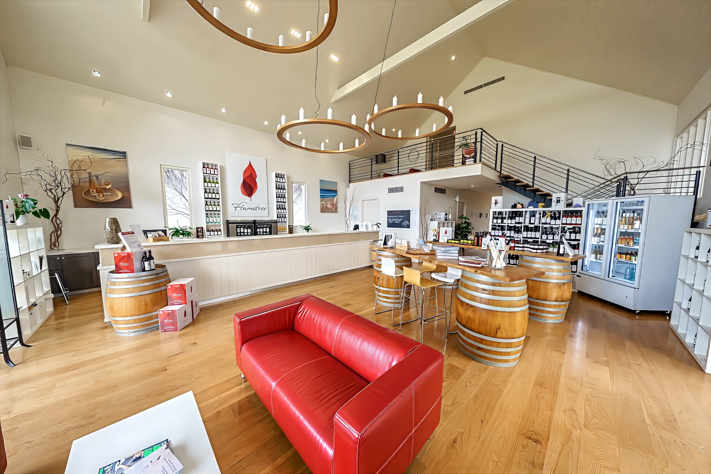 Winery tasting room interior with red sofa and wine barrels