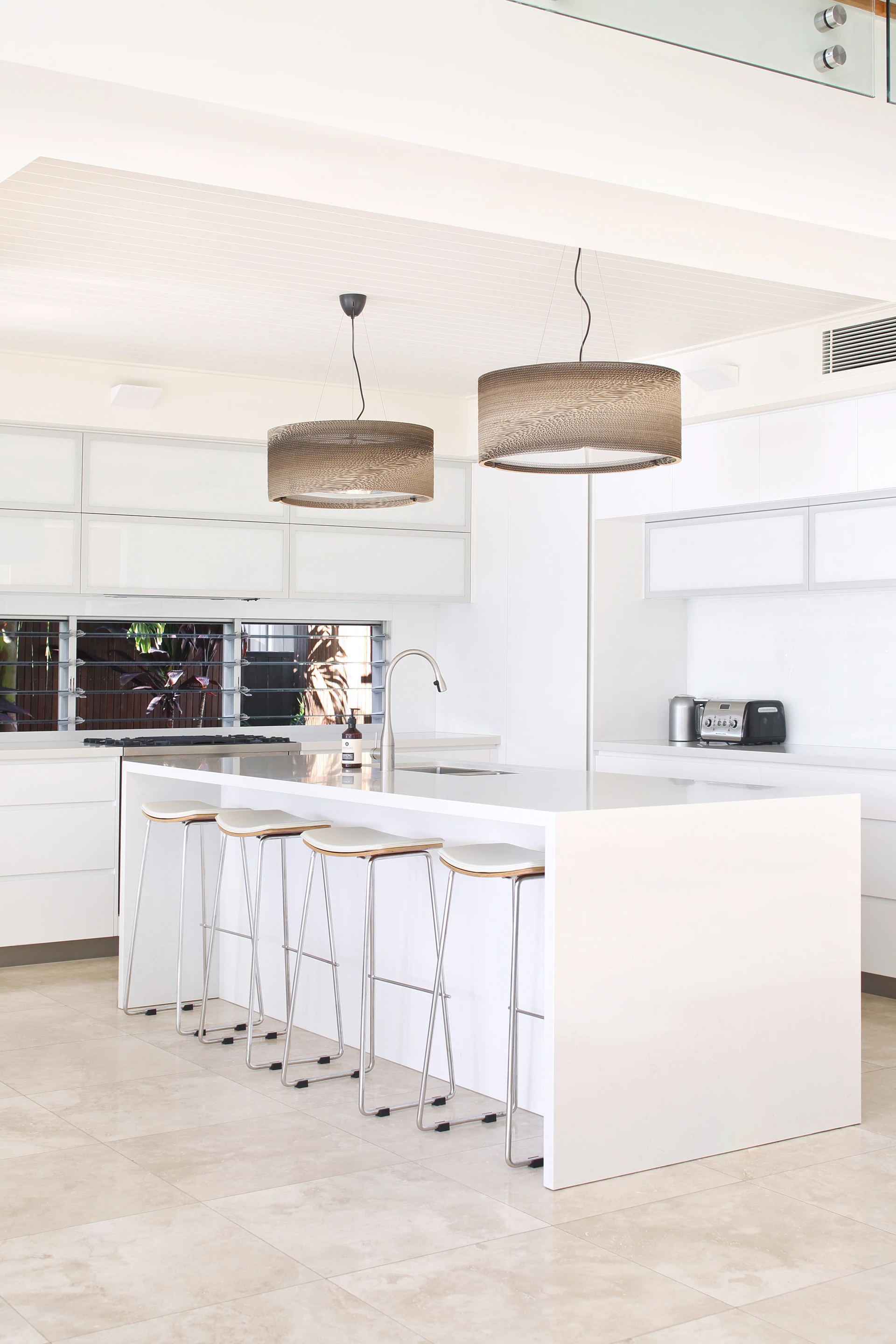 Modern white kitchen with island and bar stools