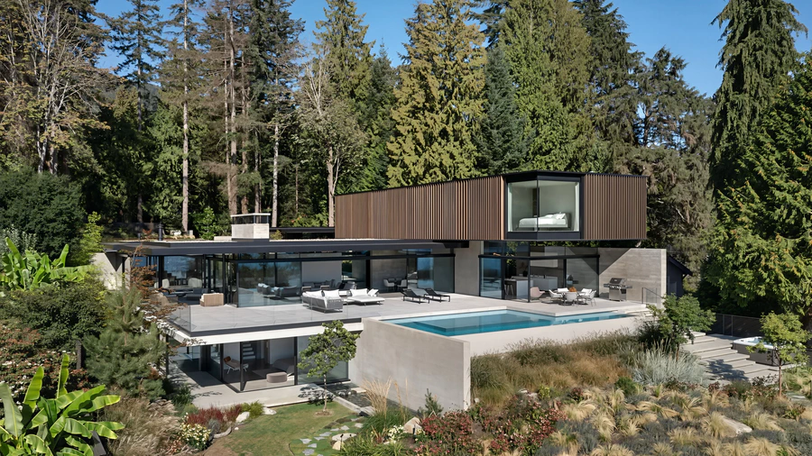 Contemporary house surrounded by trees featuring outdoor swimming pool