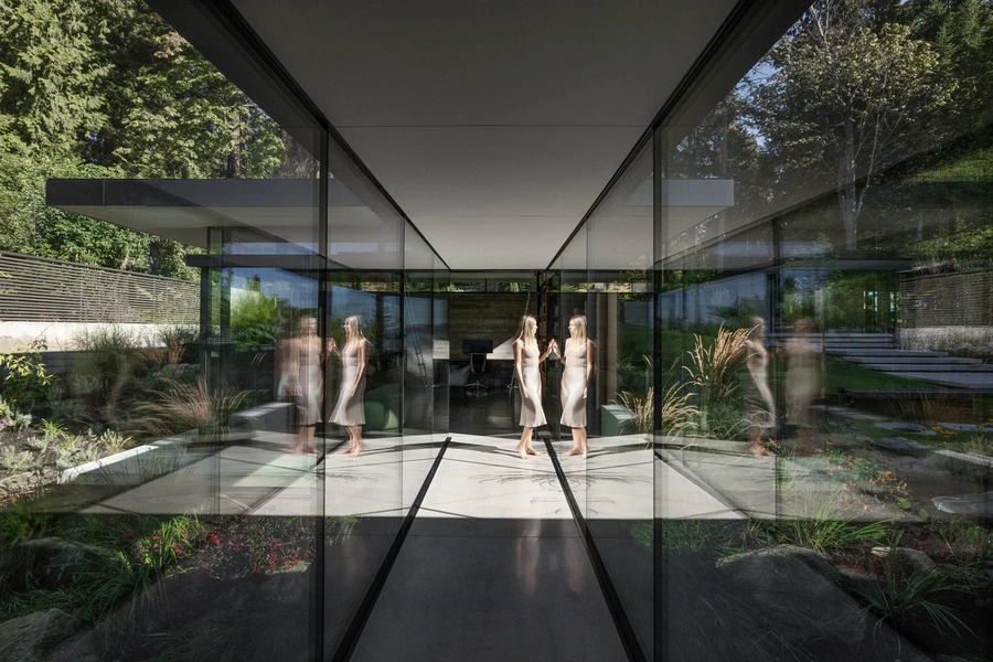 Glass corridor connecting garden and interior space