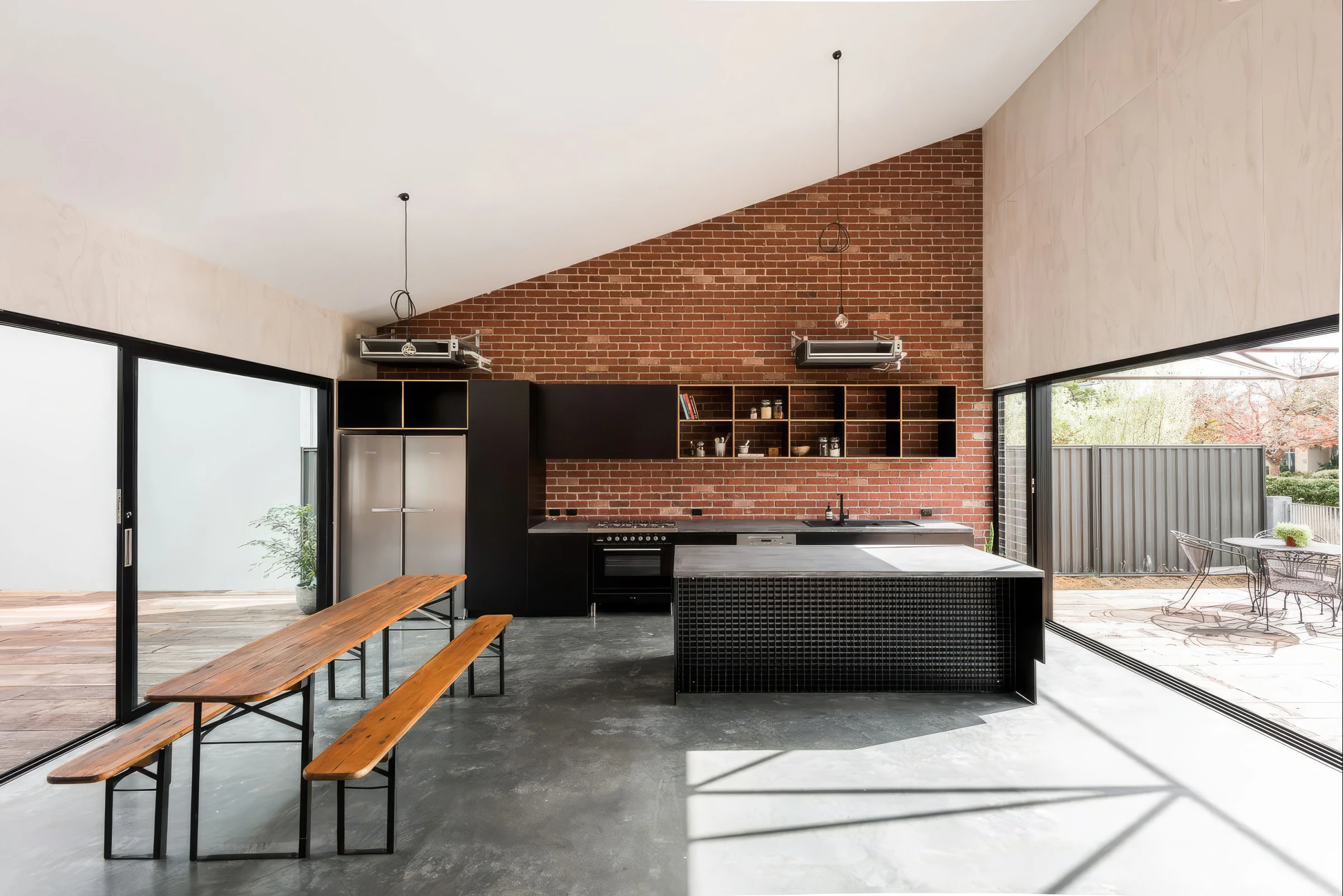Industrial kitchen, red brick wall and polished concrete floor