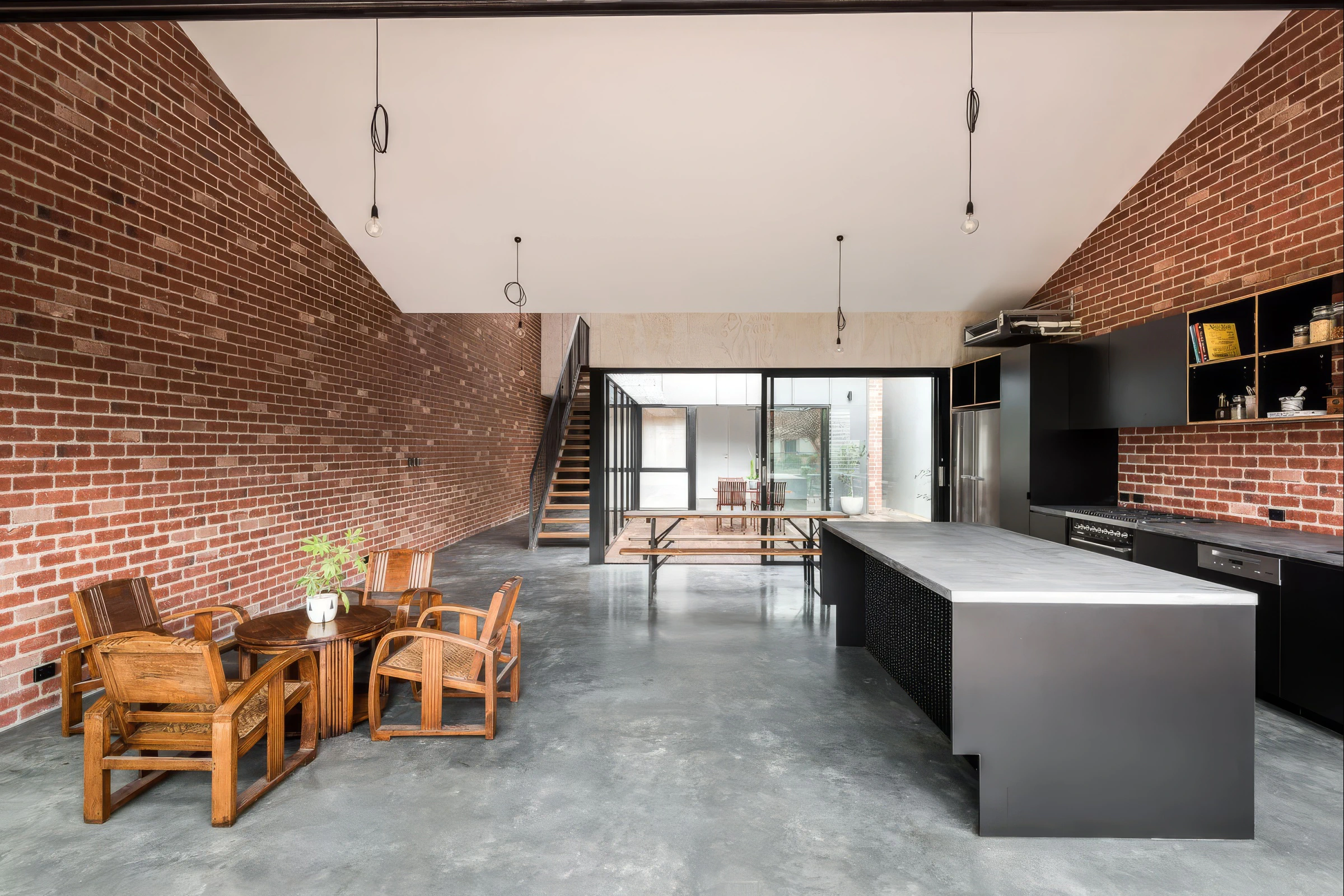 Brick warehouse living area, concrete floor and black kitchen