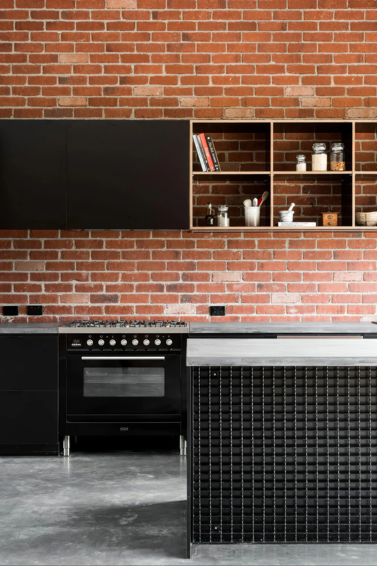 Industrial kitchen brick wall, black steel cabinetry and concrete floor