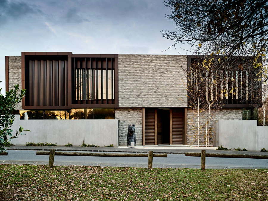 Contemporary residential building with brick and metal façade and vertical wooden accents