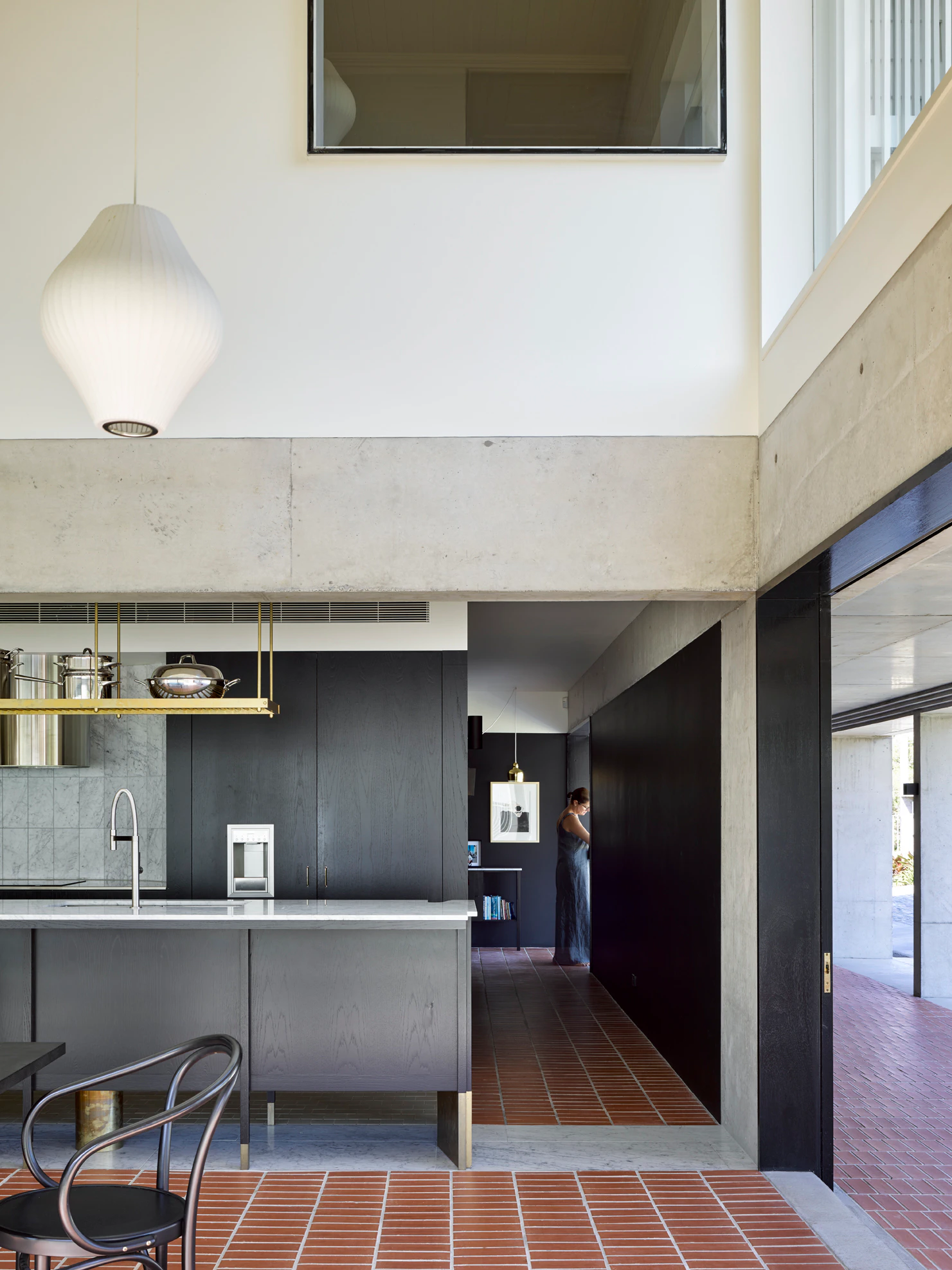 Modern kitchen interior with tiled floor and large pendant light