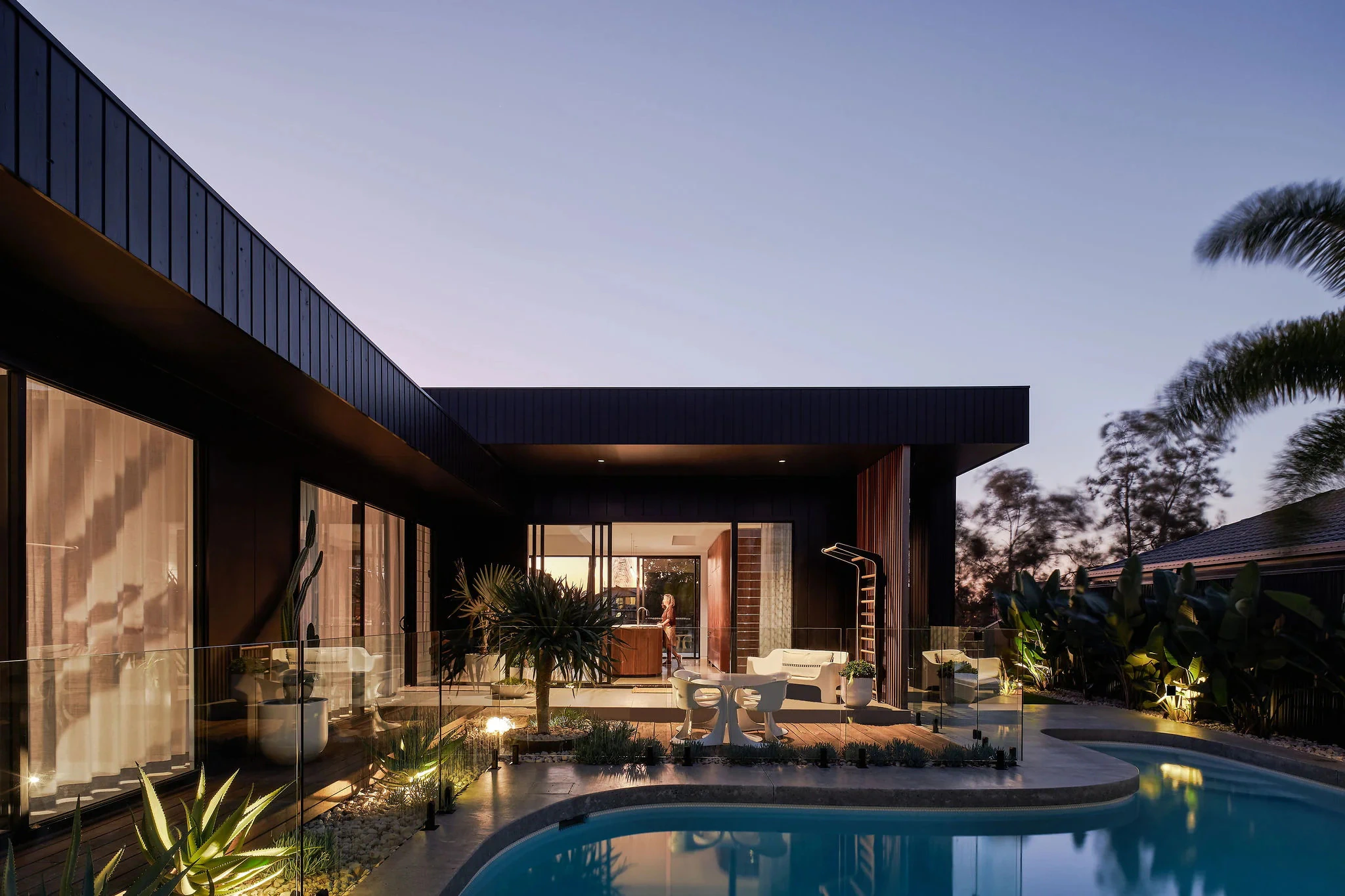 House exterior beside swimming pool at dusk