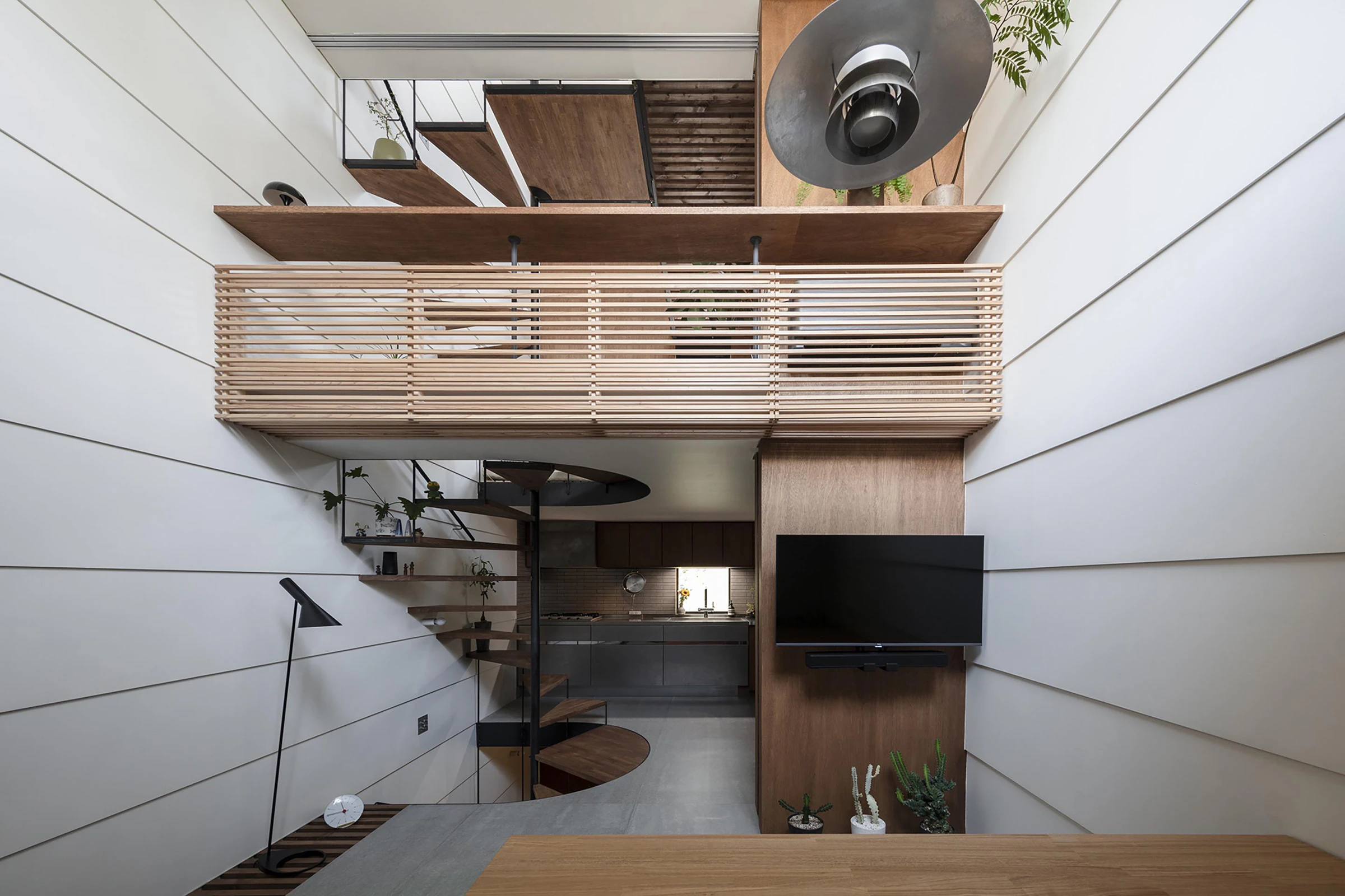 Vertical machiya interior, timber balustrade and circular stair void