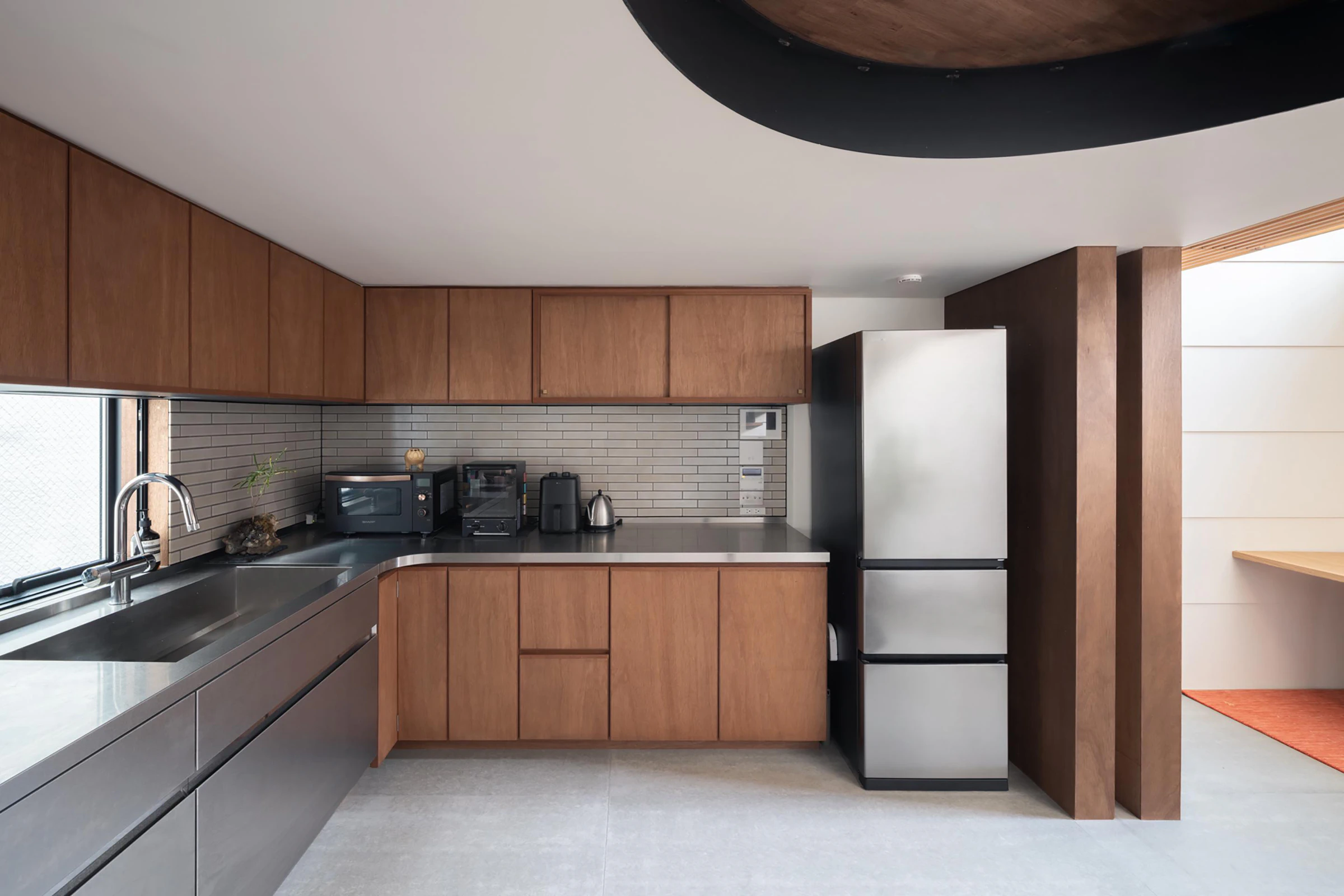 Compact Tokyo kitchen timber cabinetry and stainless steel benchtop
