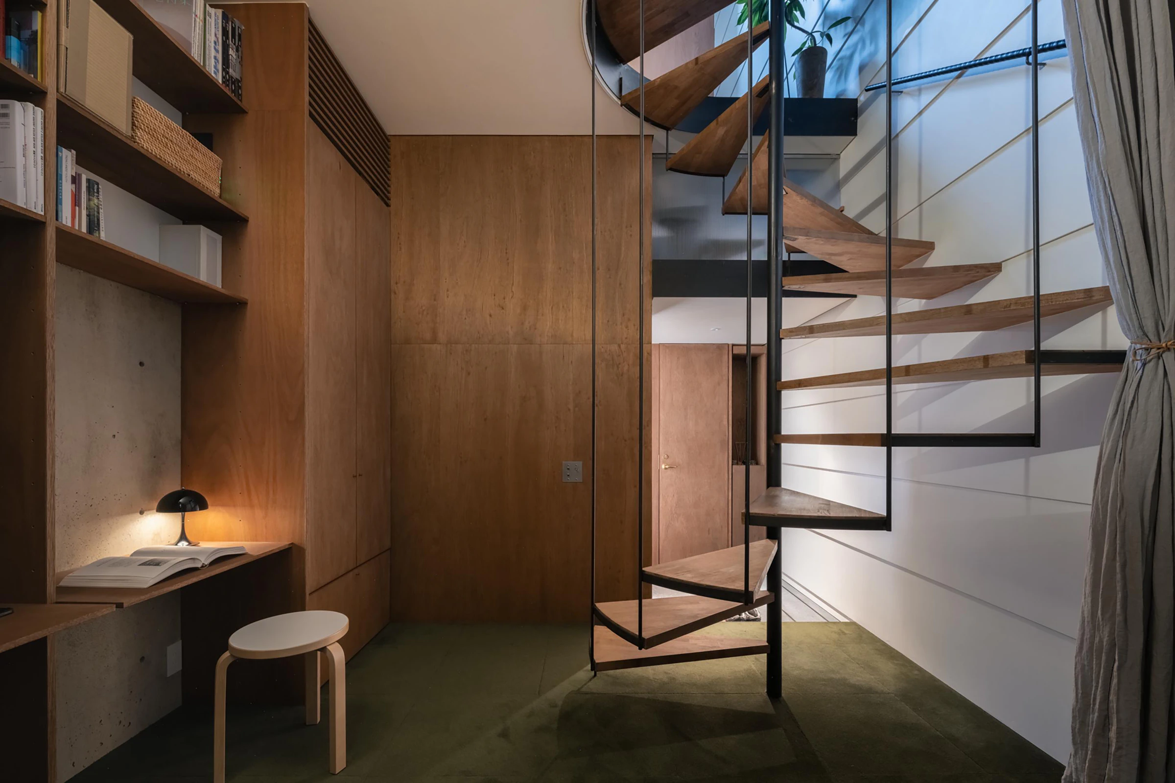 Timber stair and study shelves in compact vertical machiya house
