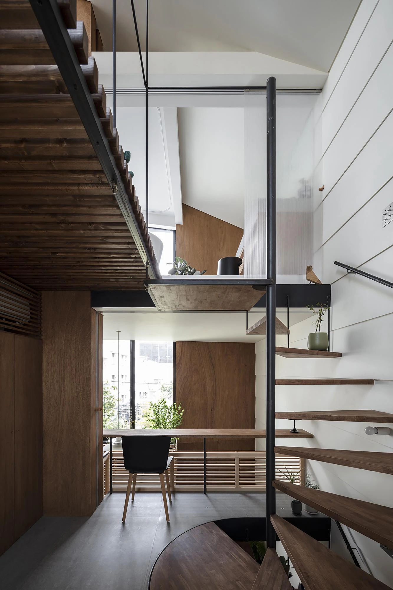 Compact Tokyo townhouse interior, timber stairs and central void