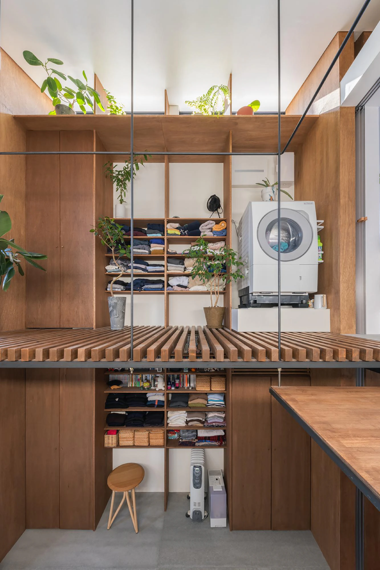 Vertical machiya interior, timber storage and open mezzanine levels