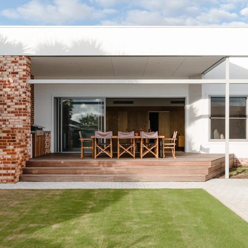 Outdoor covered patio area with wooden deck and dining table