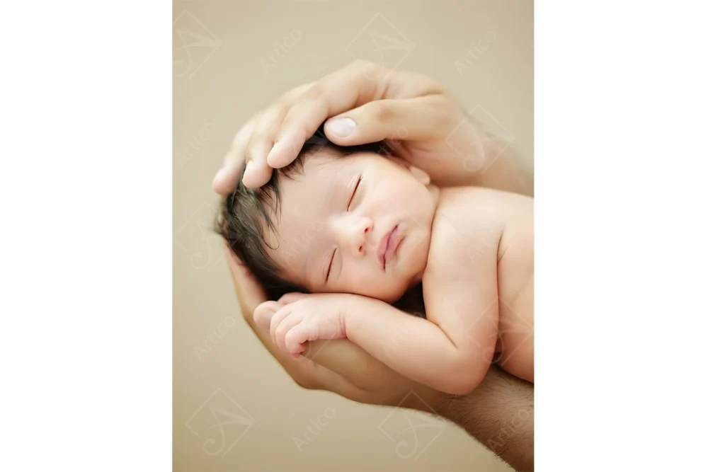 Articoo - Cute newborn baby in father's arms on beige background - Articoo_961711