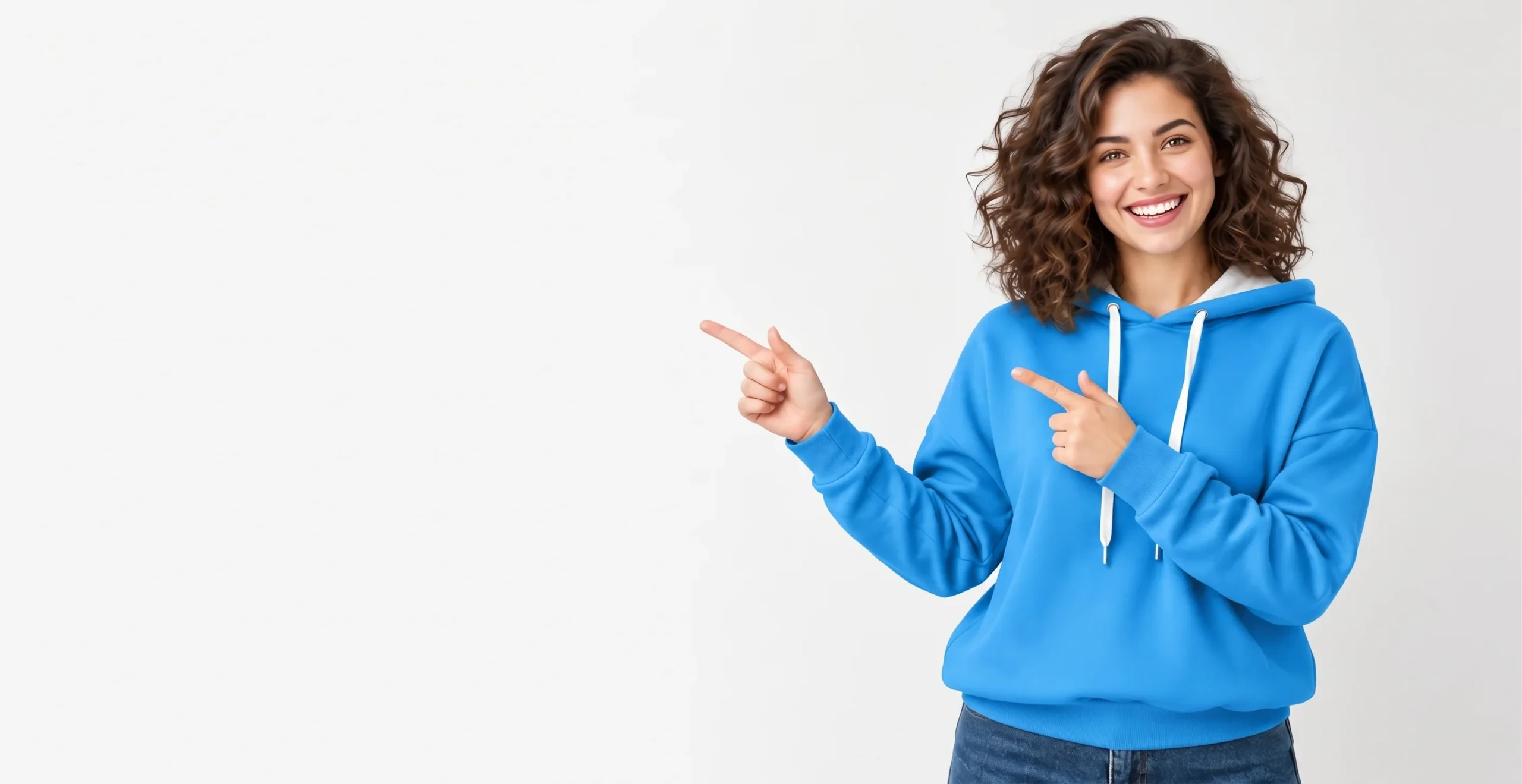 Home 1 Smiling woman in a blue hoodie pointing left against a light background.