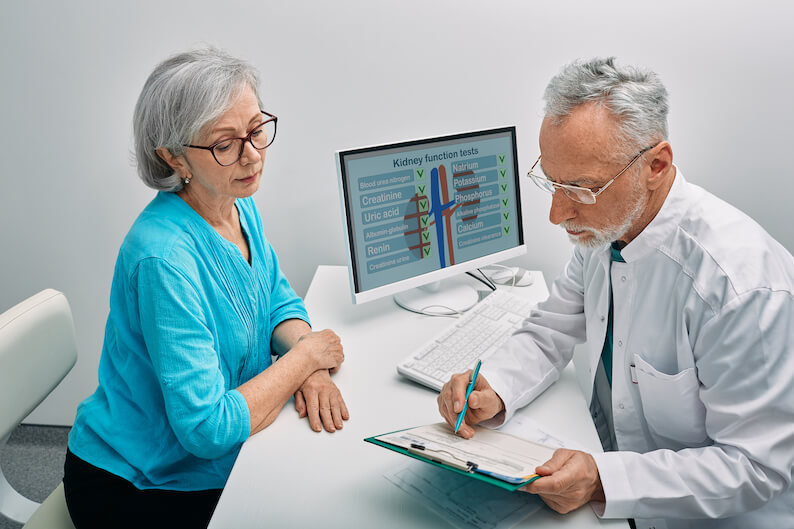 Older female adult discussing kidney health with doctor.
