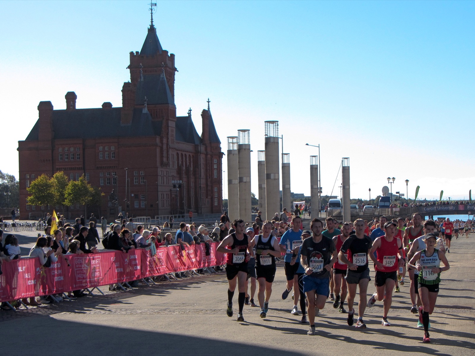 Runners in the Cardiff Half Marathon passing the Pierhead Building in Cardiff Bay