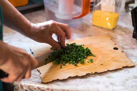 Premium Photo  Chopping parsley on a cutting board