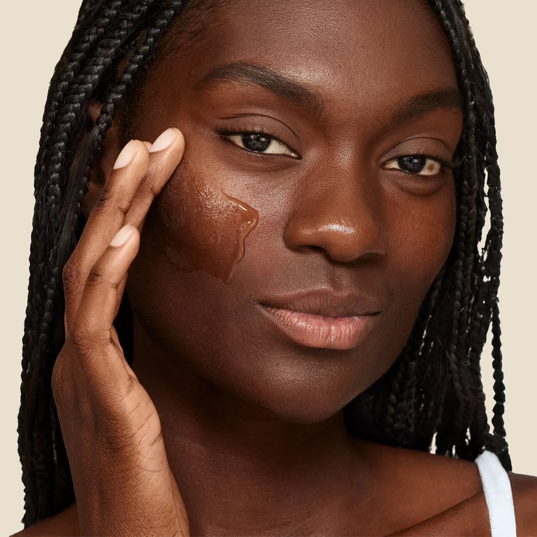 Woman putting on acne skincare