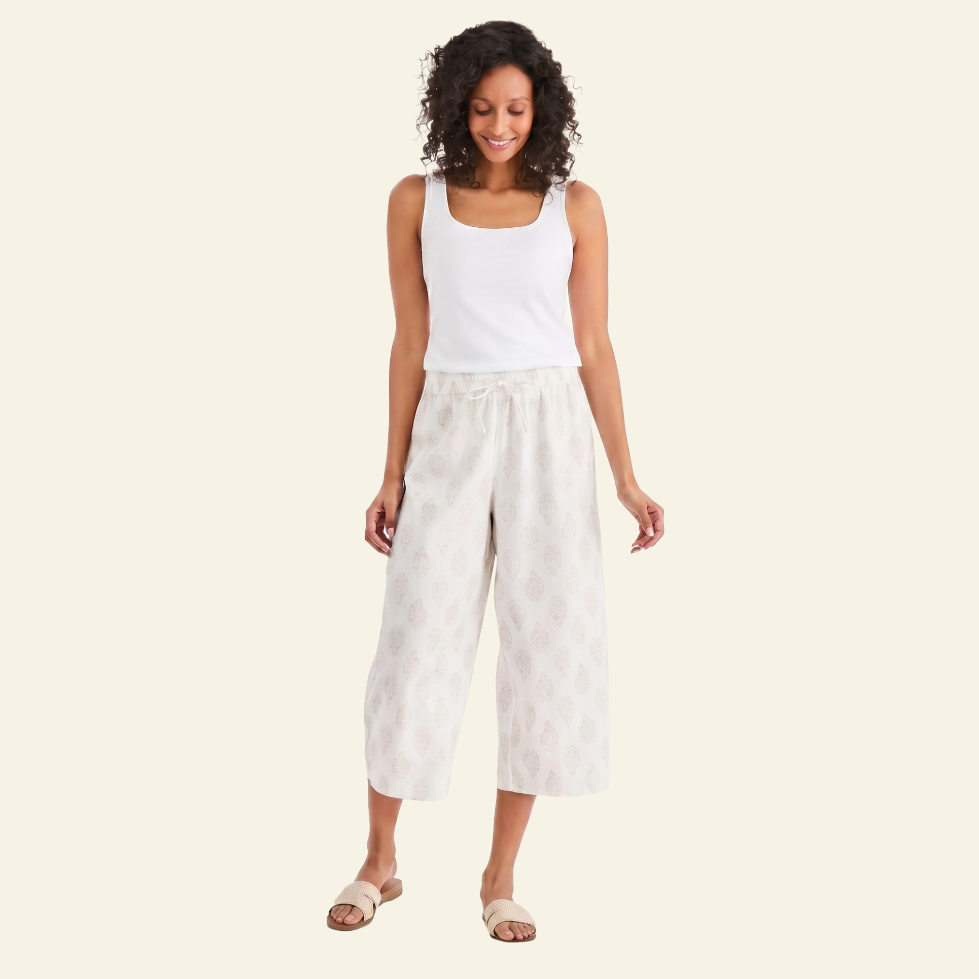 Woman in white tank top and linen pants for Euro summer trip outfit