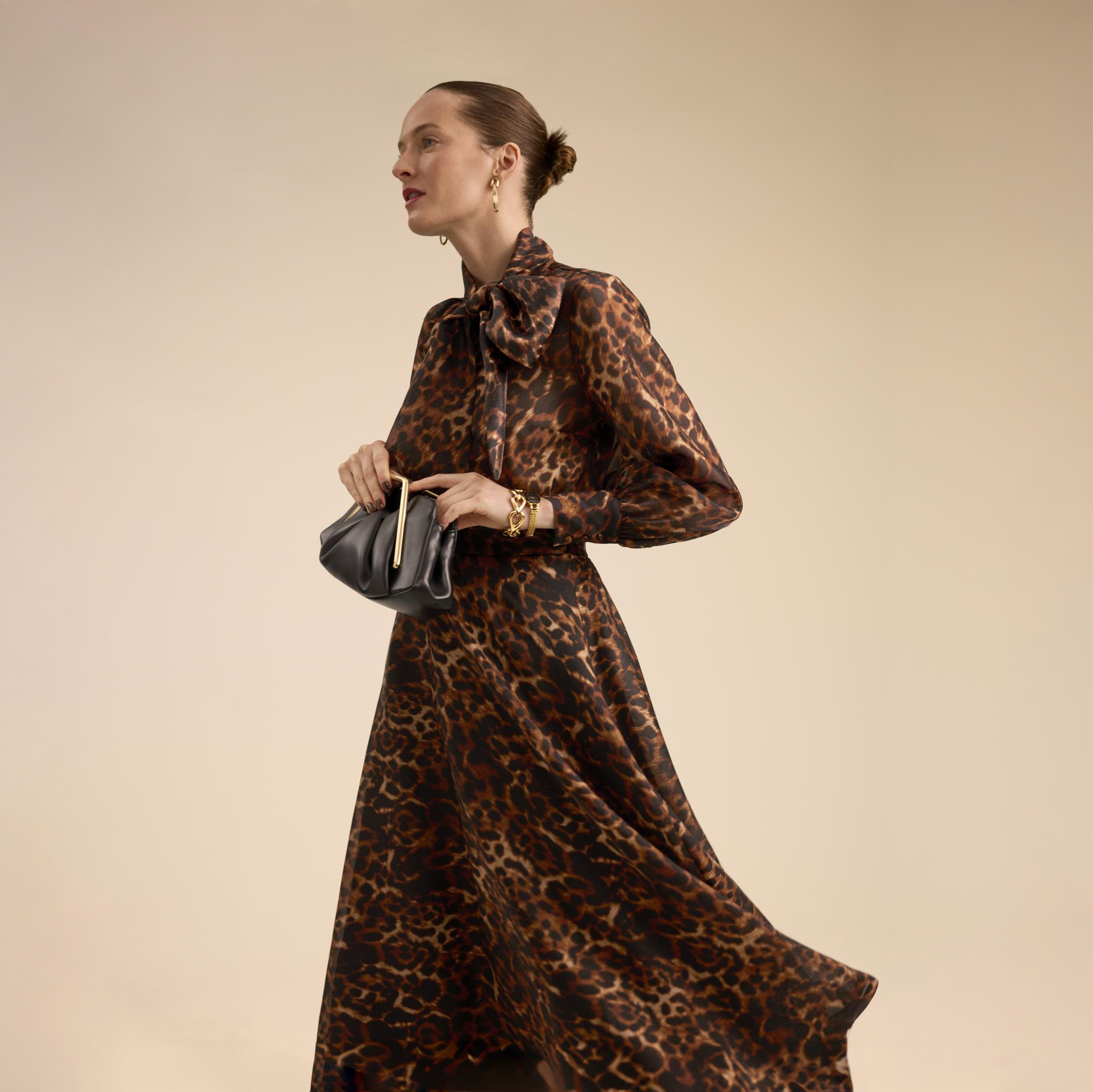 Woman in leopard wedding guest dress