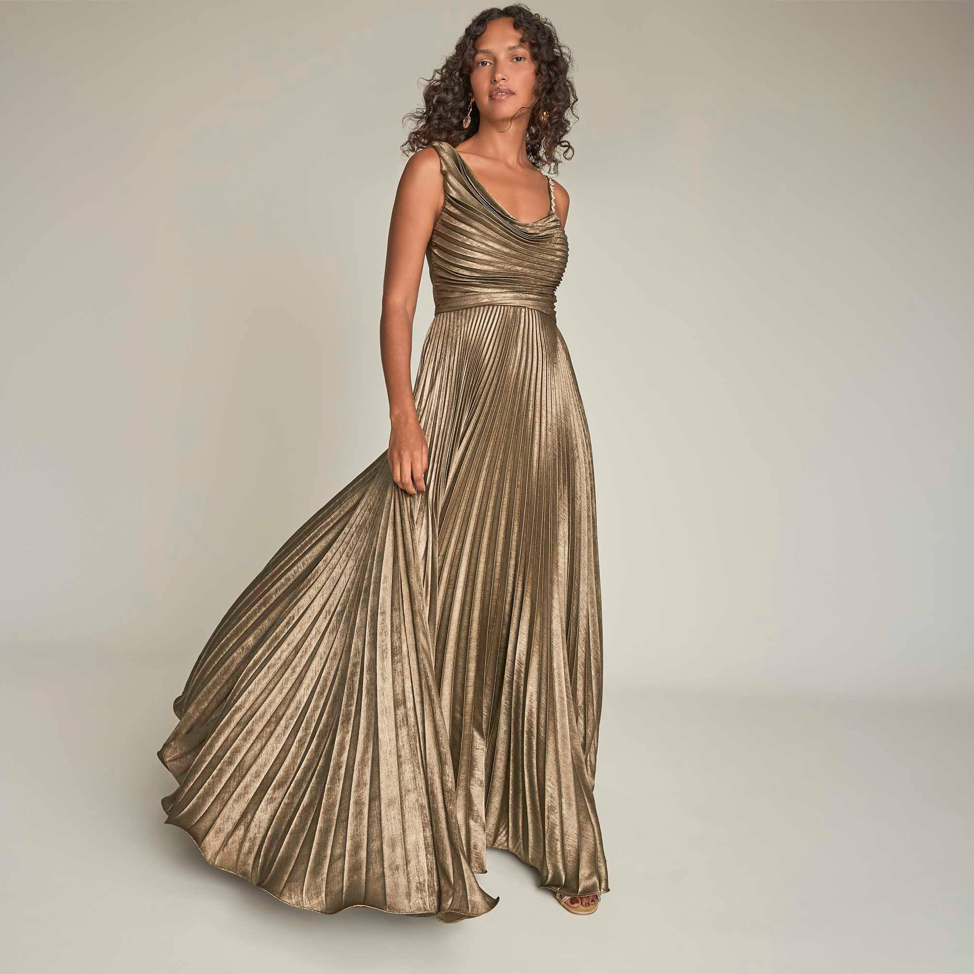 Woman in metallic wedding guest gown
