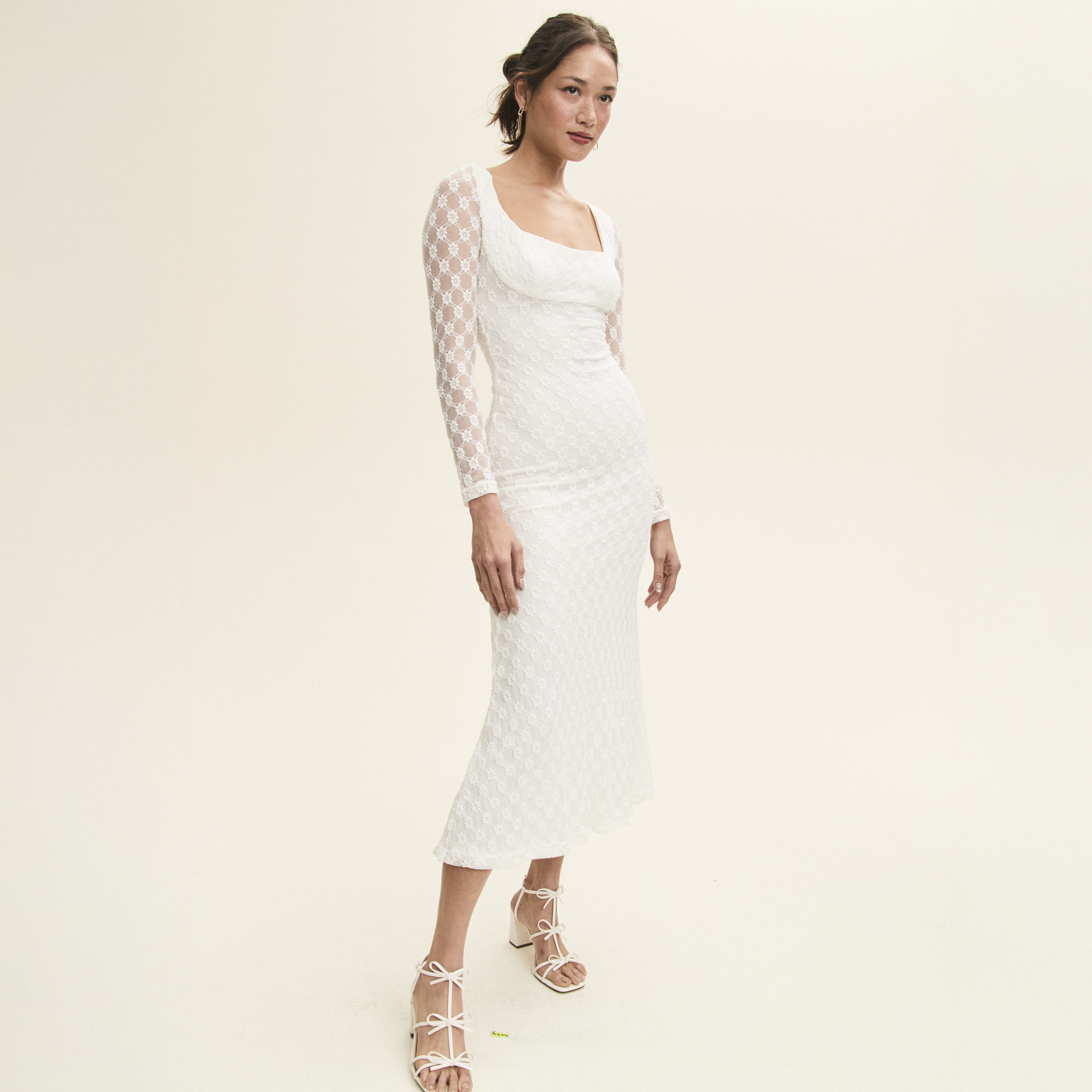 Woman in white wedding guest dress