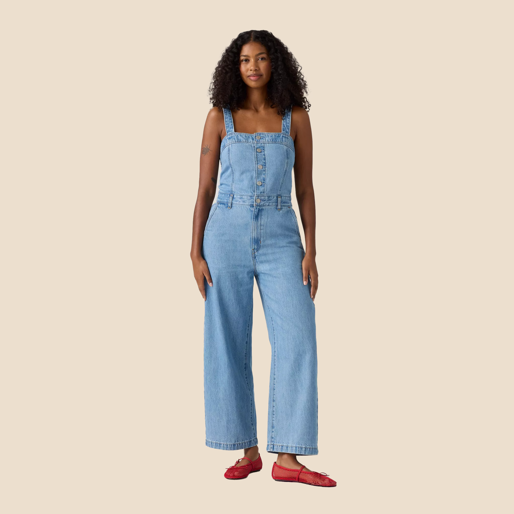 Woman in Memorial Day denim jumpsuit and red shoes