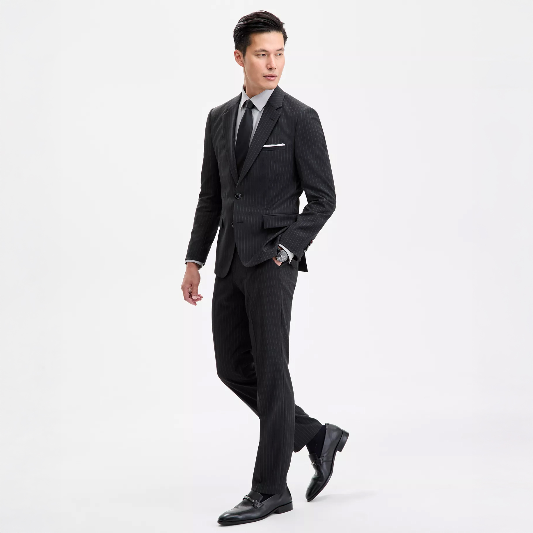 Man wearing black suit and watch