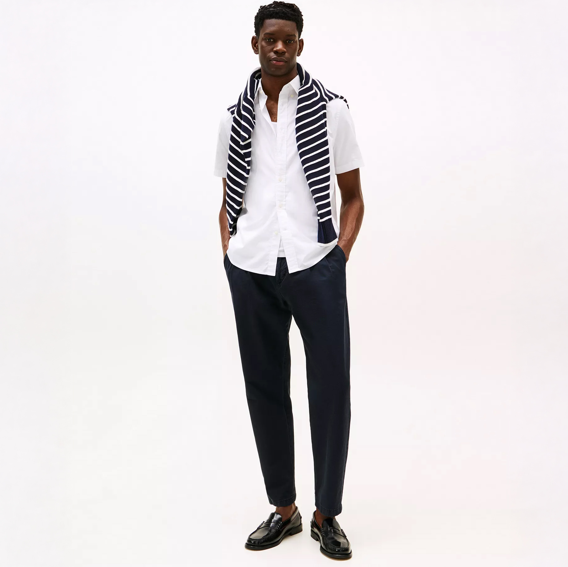 Man in white shirt and blue slacks