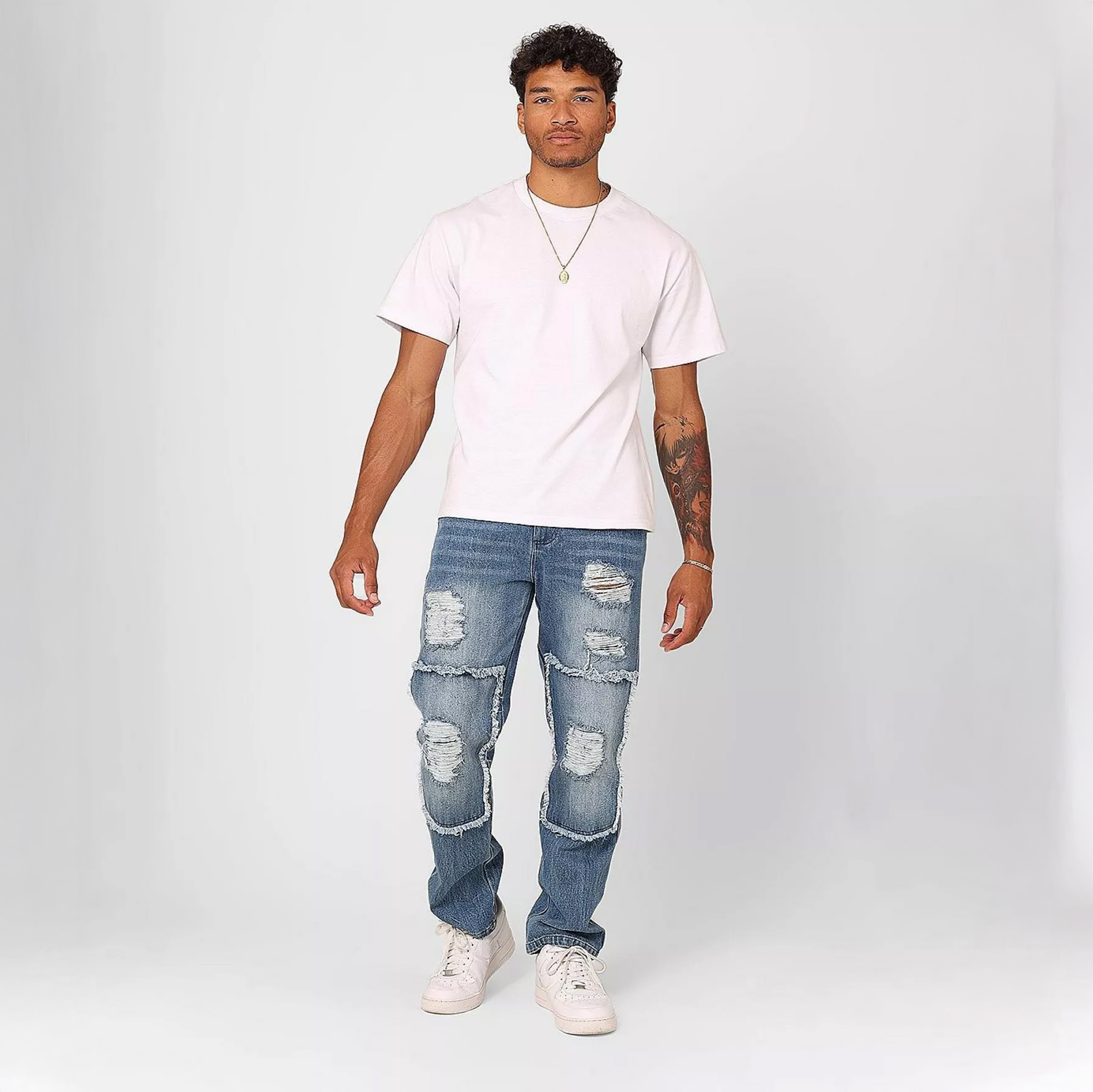 Man in white shirt, denim, and white shoes