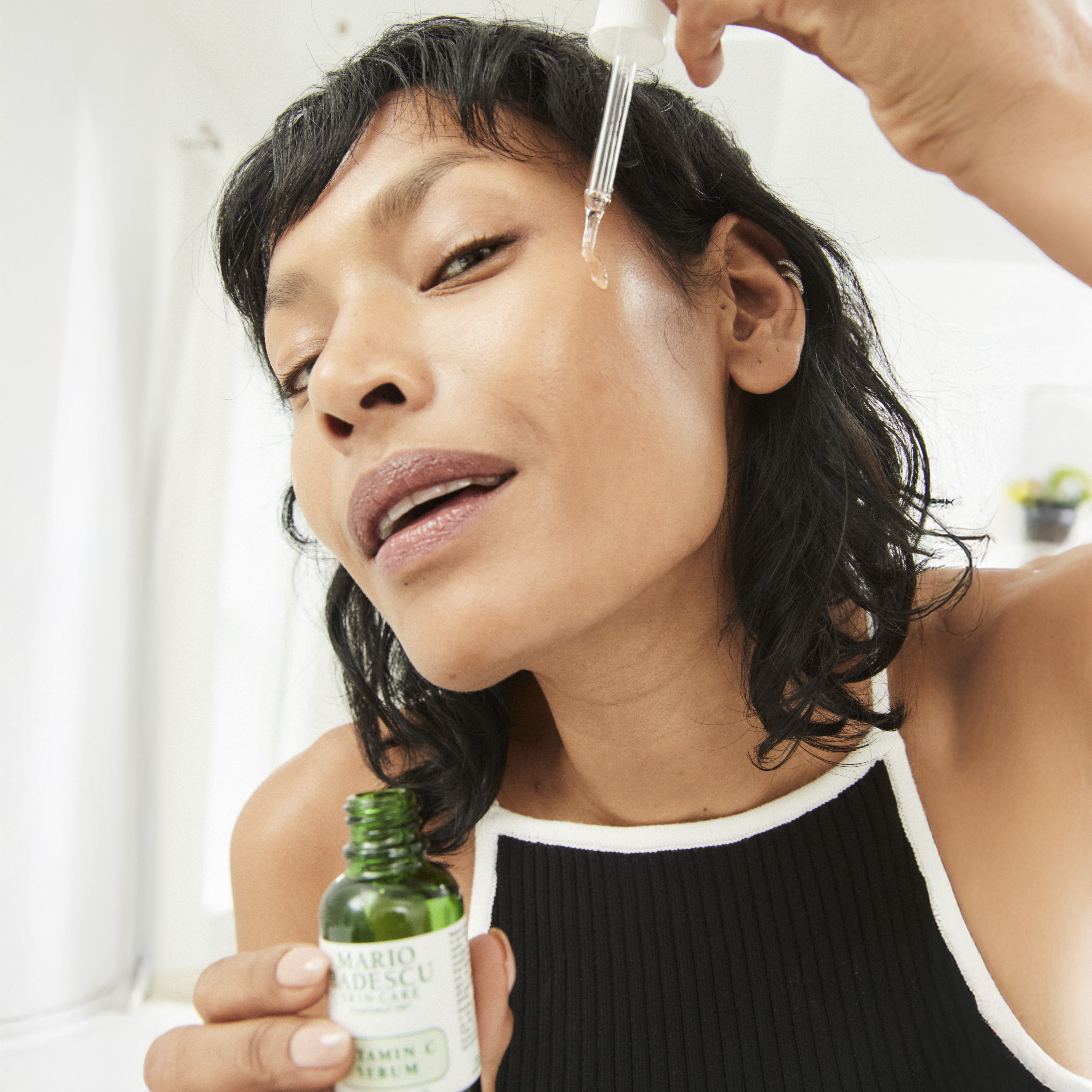 Woman applying face oil