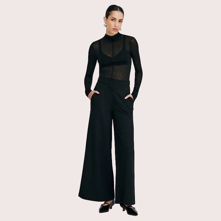 Woman in black top with bralette and wide-leg pants
