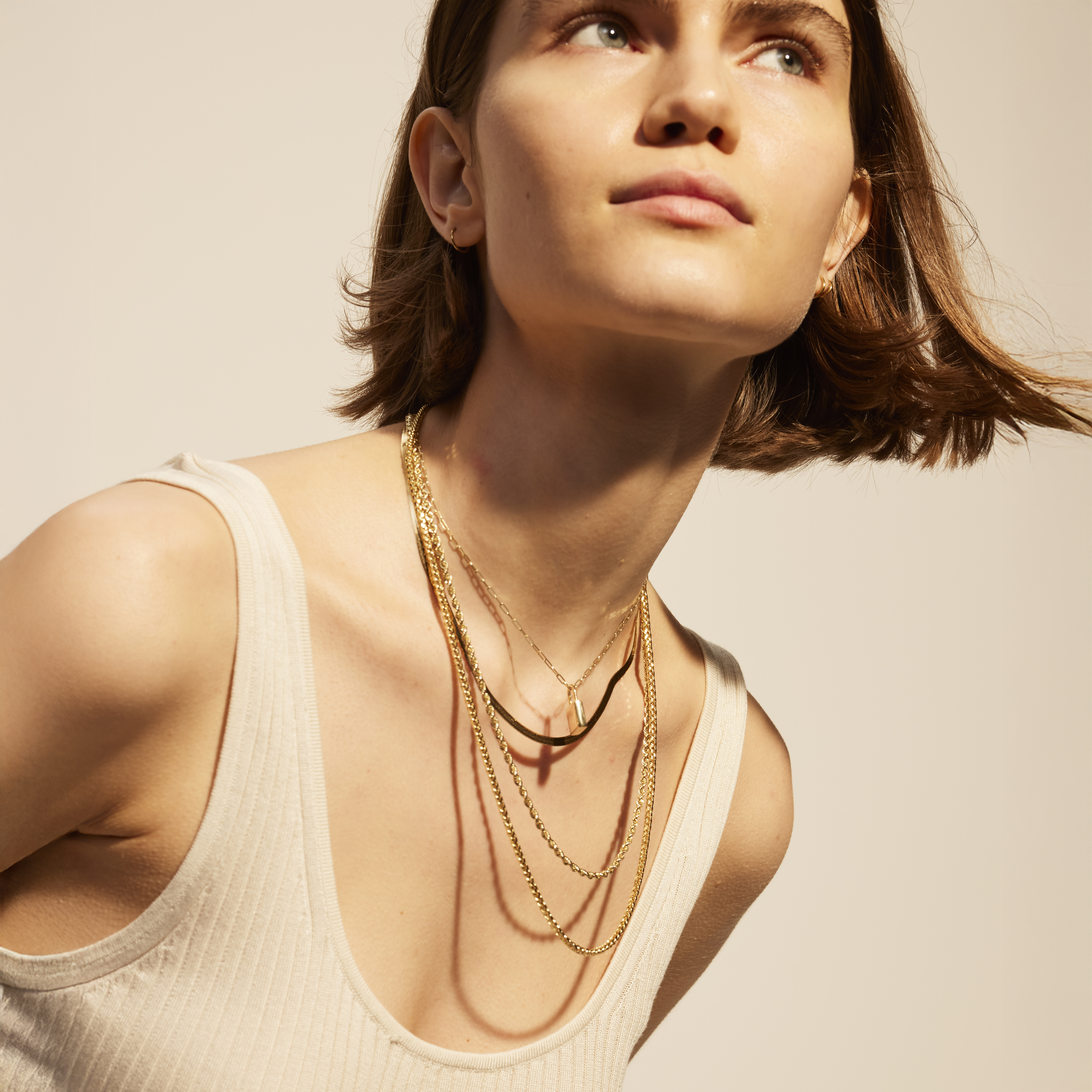 Woman wearing dainty gold necklace