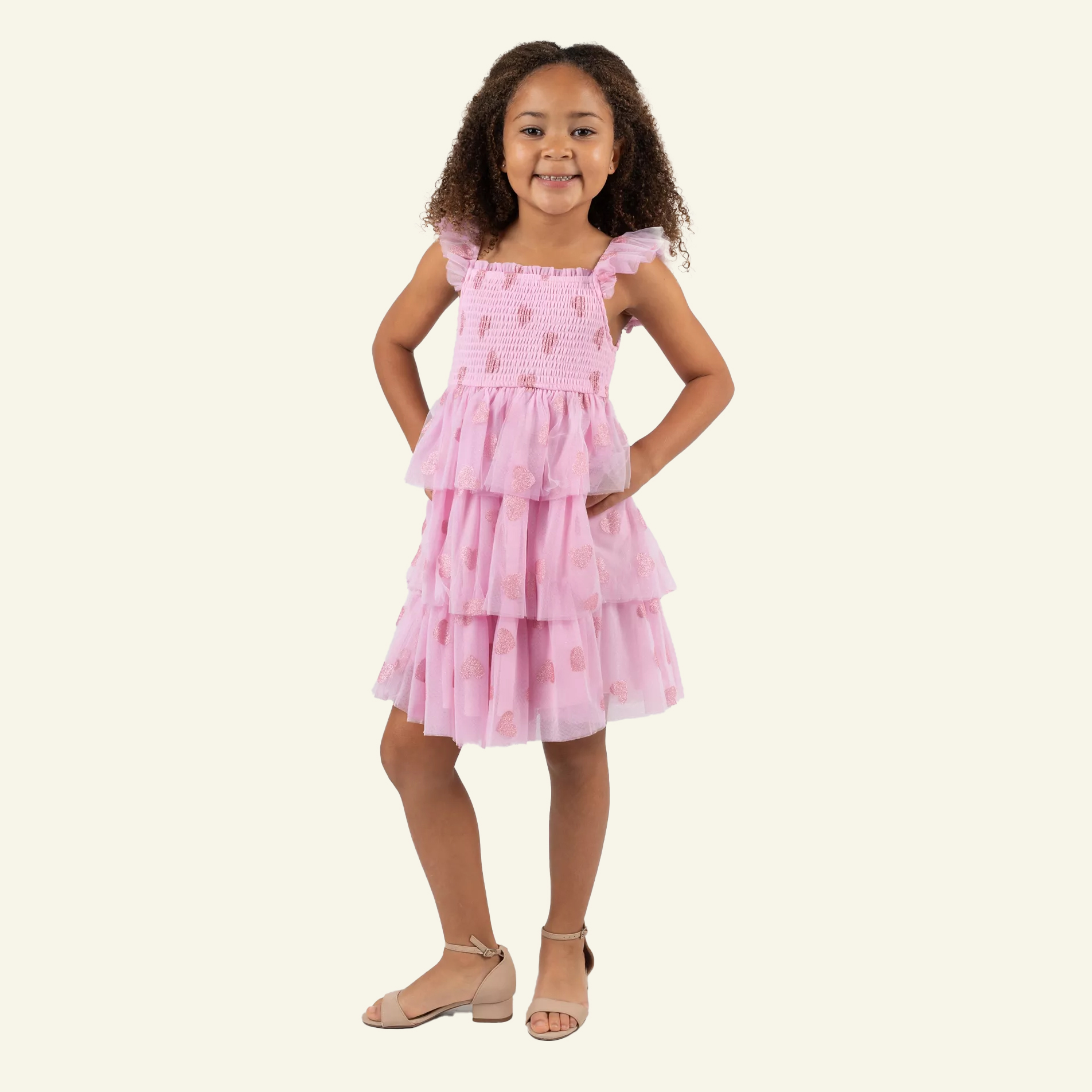 Girl in Valentines day pink glitter heart dress